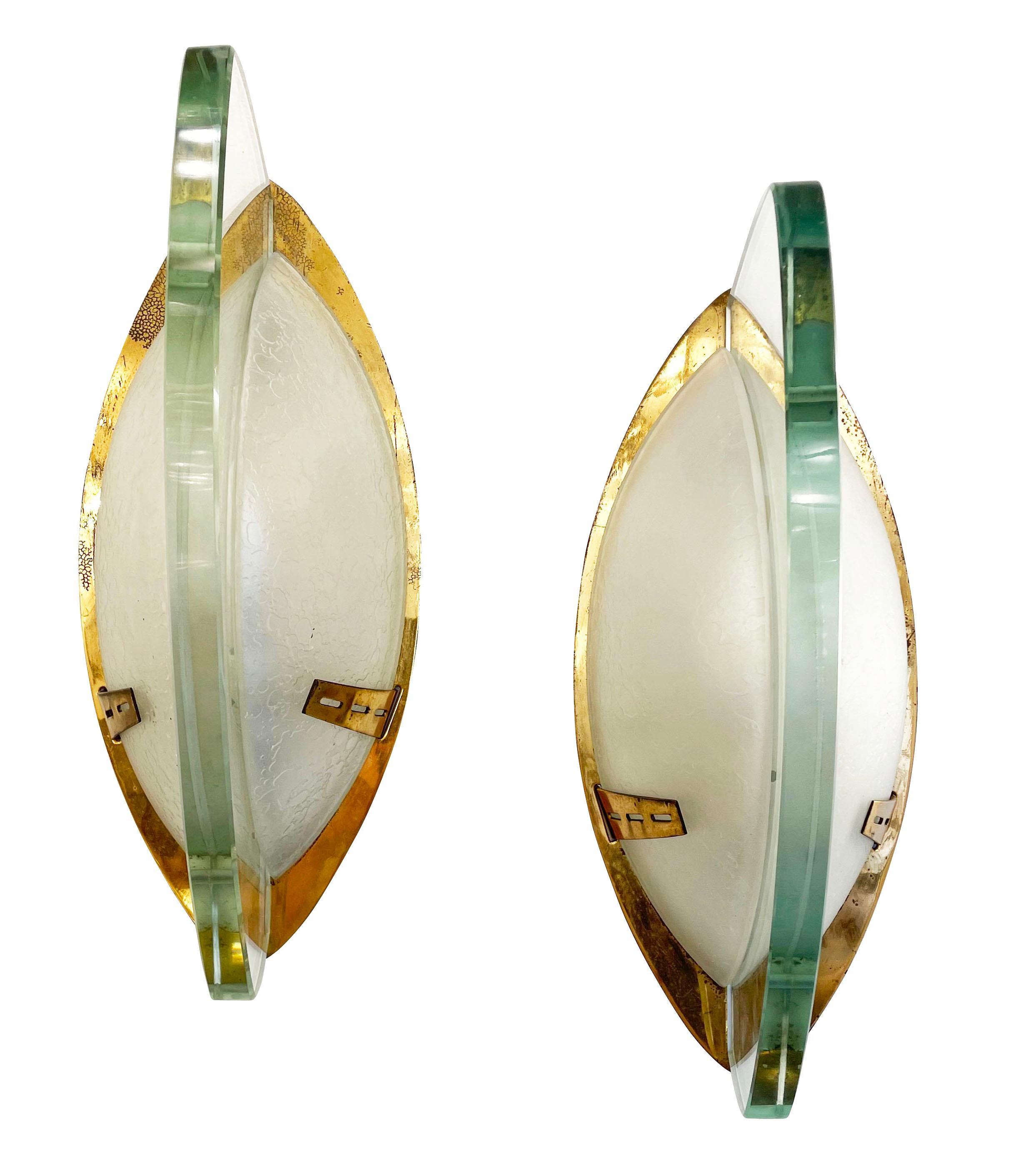 Extremely rare pair of sconces by Stilnovo (Marked with original label) each featuring a clear green central glass and two flanking textured frosted glasses. The framing is brass and holds one E26 socket.

Condition: 
Excellent vintage condition,