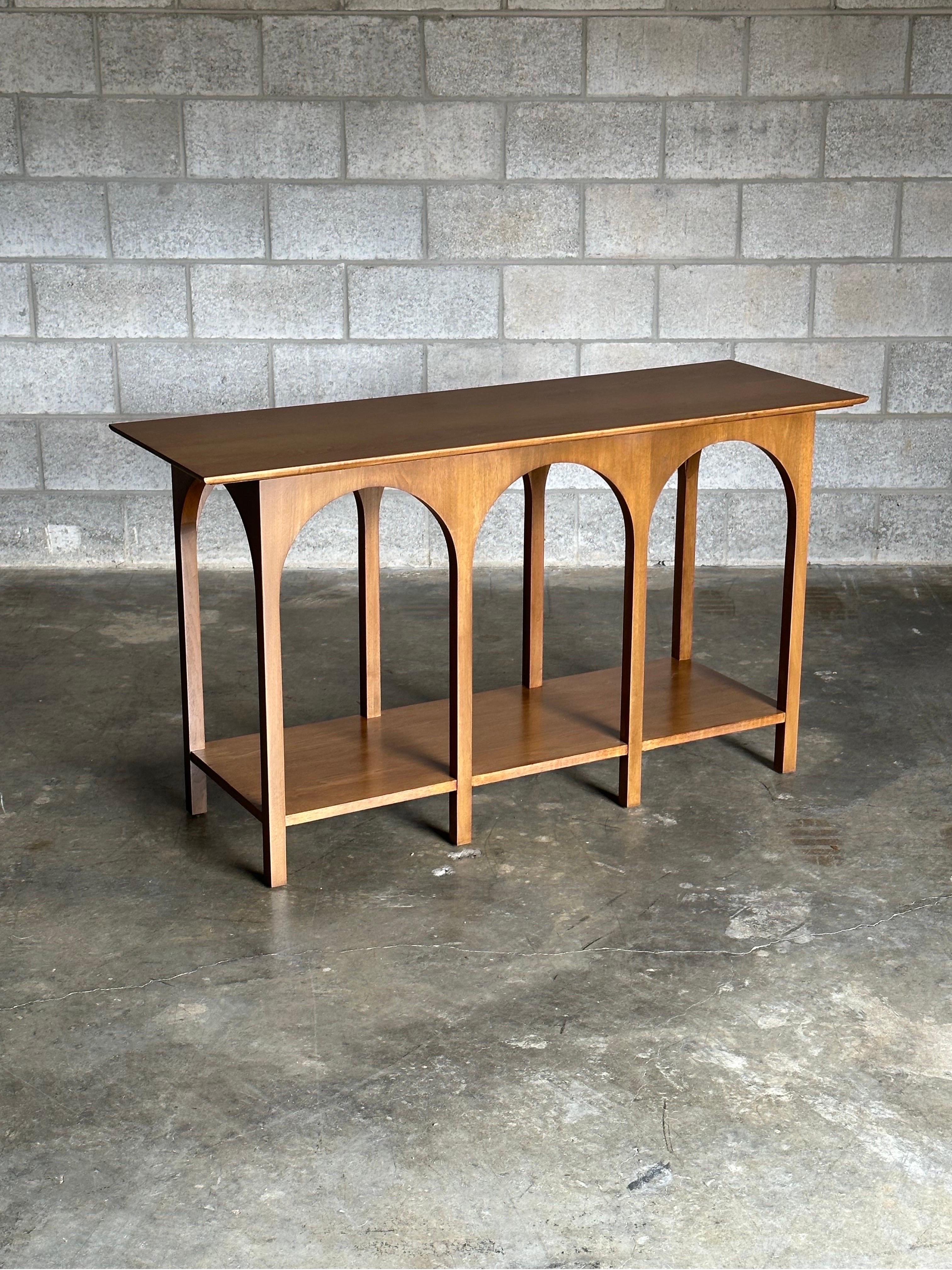 A stunning and rare console table designed by T.H. Robsjohn-Gibbings for Widdicomb, circa 1956. Features gorgeous arches creating what looks like partitioned display areas. This uncommon piece is from the line often referred to as the Coliseum