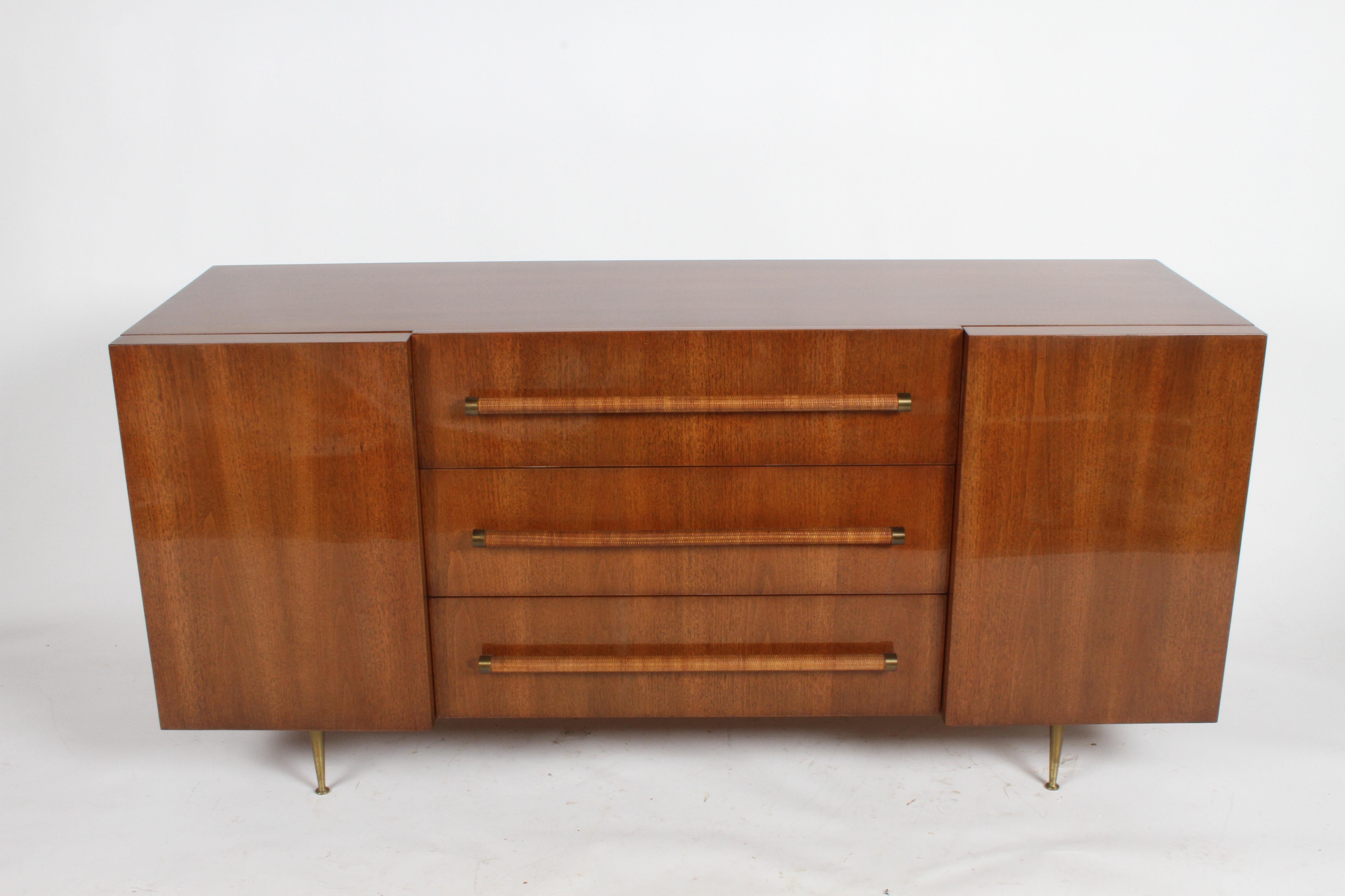 Rarely seen elegant T.H. Robsjohn-Gibbings for Widdicomb sideboard or dresser. Completely restored cabinet to original color with heavy build hand polished clear coat. Walnut cabinet with center drawers with rattan circular handles with brass end