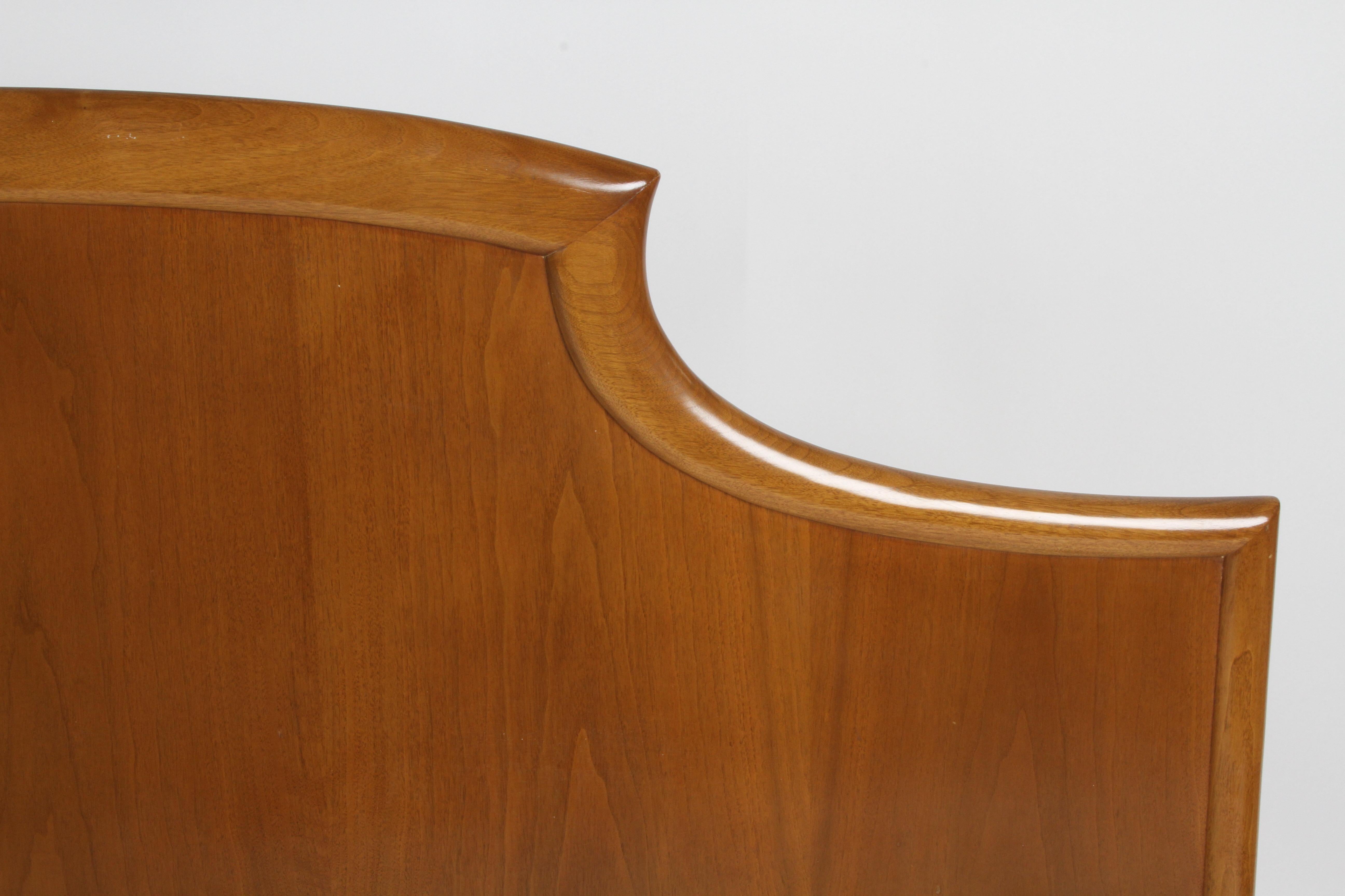 Elegant T.H. Robsjohns-Gibbings for Widdicomb sculptural king size headboard with bookmatched walnut venner in original sherry finish. This headboard is part of the seldom seen bedroom set that has the 24-karat gold-plated porcelain handles. I'm
