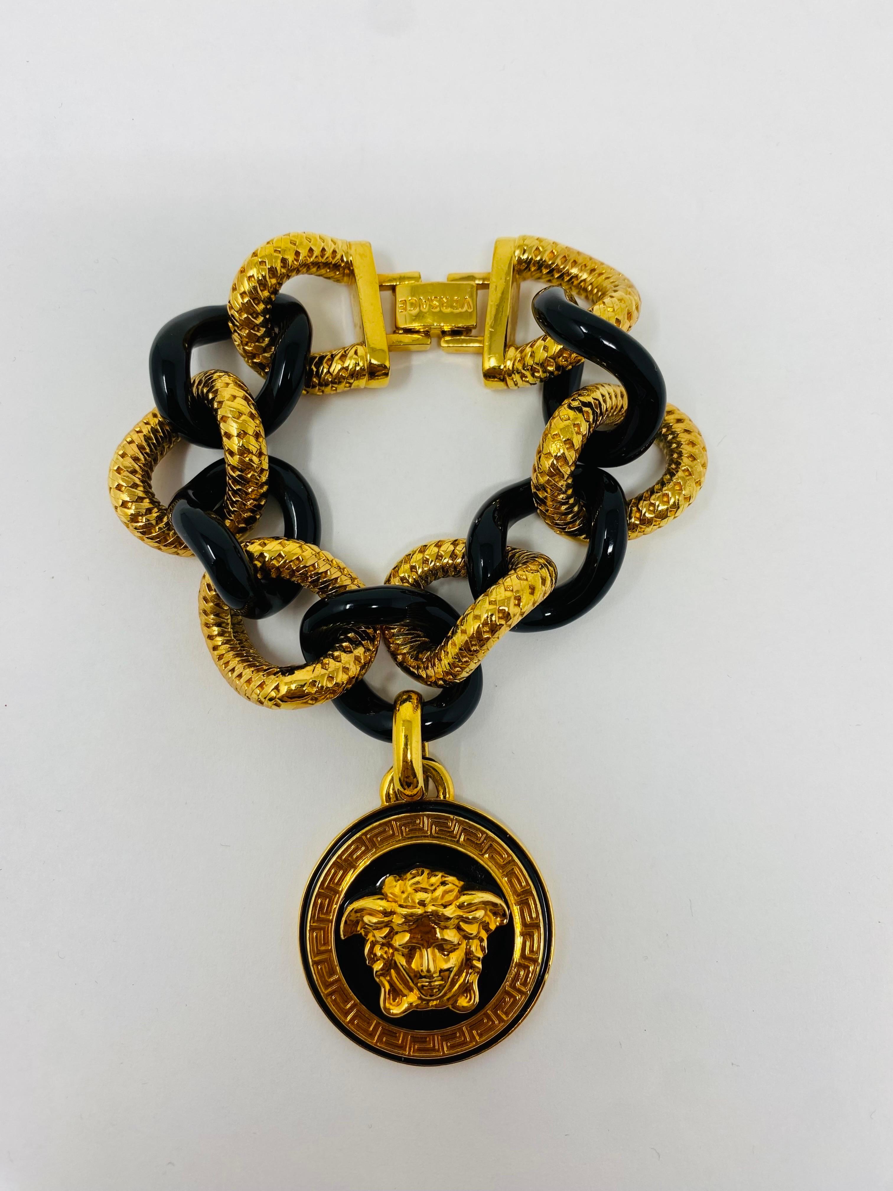 Beautiful charm bracelet by Versace. This sculptural piece is commanding and striking and chic. A bracelet alone carries the lines and codes of the Versace fashion empire. The bracelet's charm renders the house's Medusa medallion adding signature