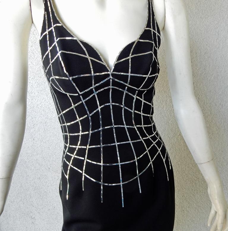 Thierry Mugler revisits his 1990-91 Spider creation in this rare Mugler Couture 2001 spider dress.

Fashioned of fine black wool with silver horizontal and vertical tubular web lines handsewn to create dimensionality.  Form fitting dress featuring