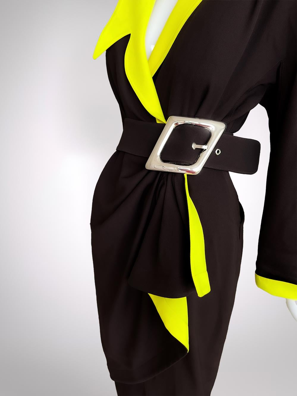 Sharp, seductive, and unapologetically commanding - this Thierry Mugler masterpiece from the Hiver Buick Collection FW 1989/90 is a dream of architectural tailoring and kinetic drama. Mugler, the maestro of sculptural fashion, creates this dark