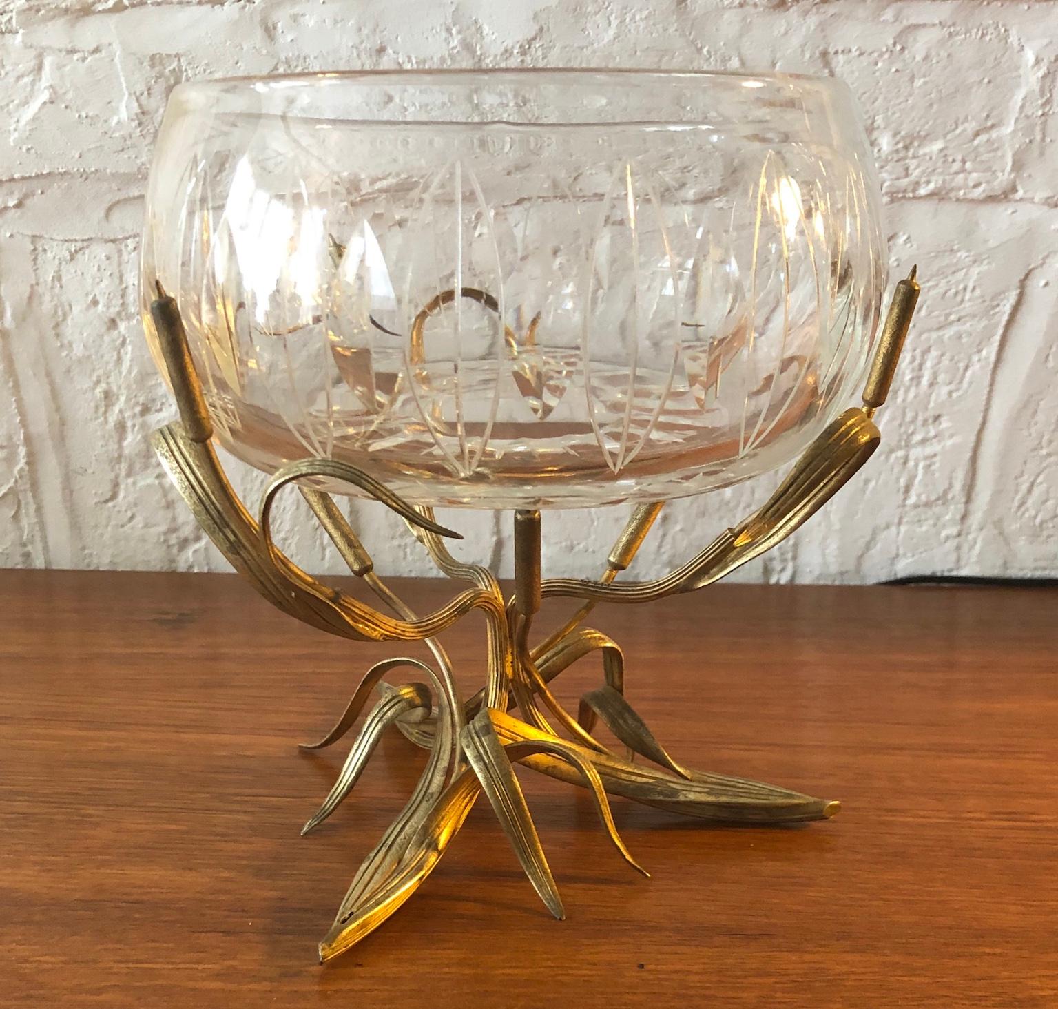 Thomas Webb & Sons, cut glass centrepiece bowl on gilt bronze stand, England, 1950s

Exquisite Thomas Webb & Son cut glass centrepiece bowl on gilt bronze stand. 
Heavy cut glass bowl with leaf shape decoration, and soft thick cut rim, the gilt