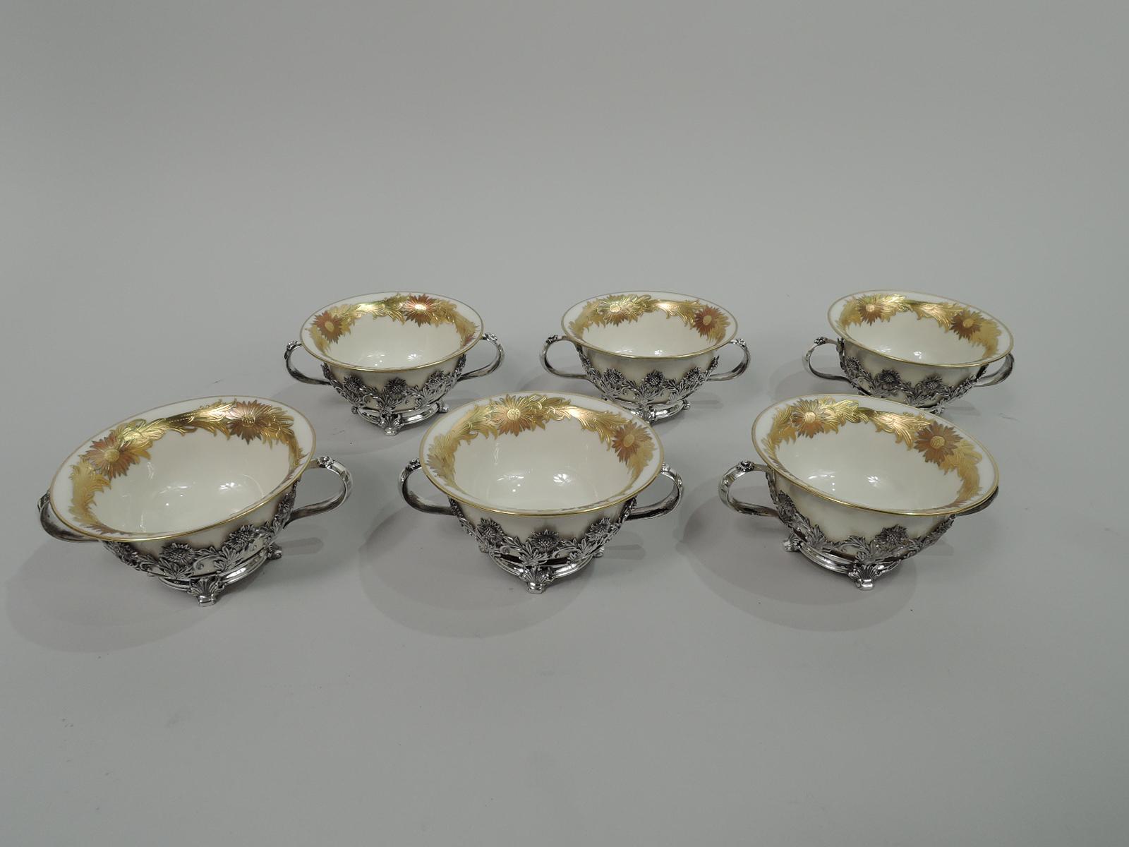 Set of 6 Chrysanthemum sterling silver bouillon bowl holders. Made by Tiffany & Co. in New York, ca 1910. Each: Curved and open sides comprising joined stem flowers. Flower-capped looping side handles. Foot ring with 4 scallop-shell supports. Fully