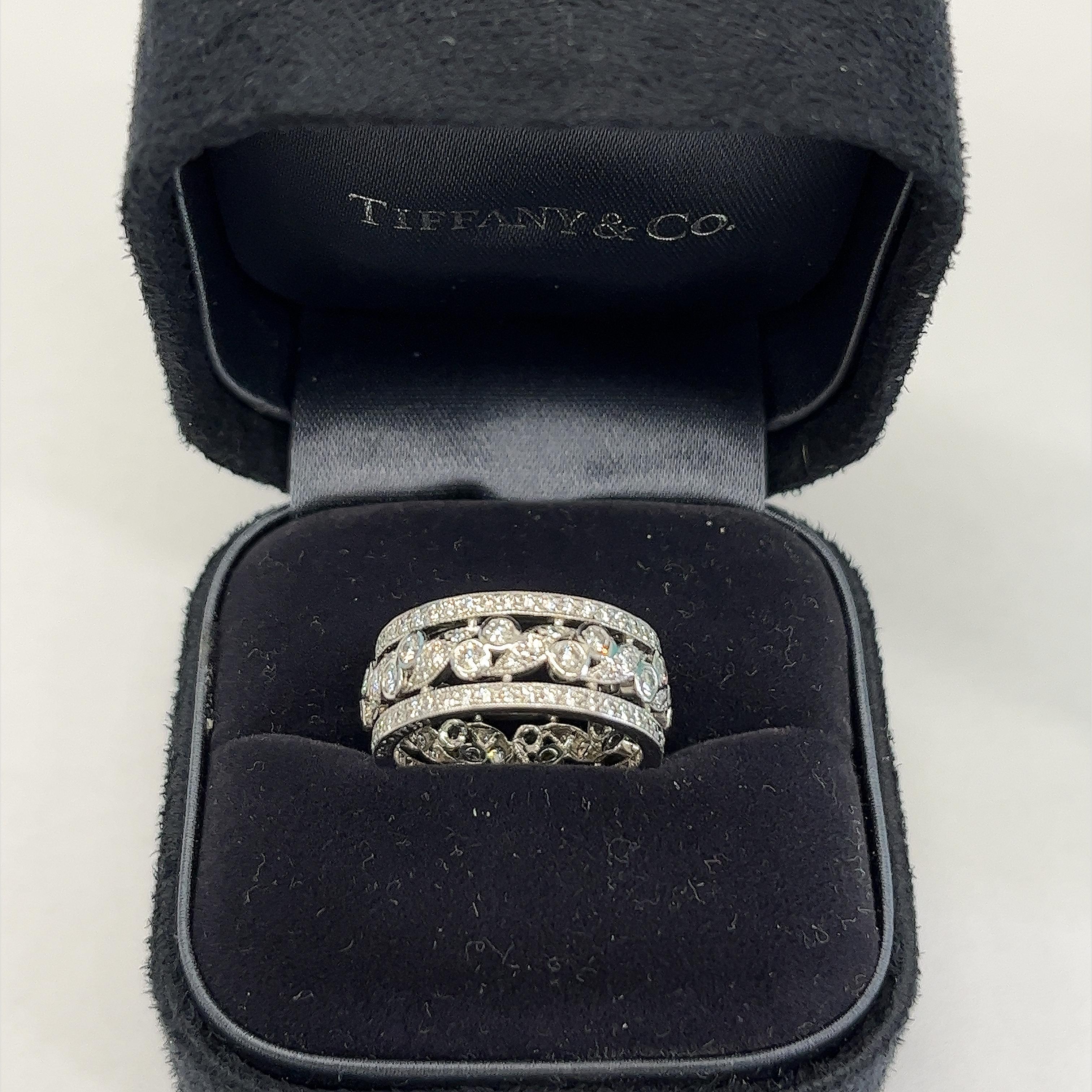 
The Rare Tiffany & Co. Diamond Scroll Wide Band Ring is quite a stunning piece! 
This ring typically features a wide band adorned with intricate scrollwork and set with sparkling diamonds, creating a luxurious and eye-catching design set in