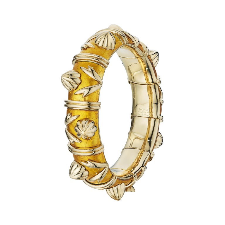 This rare Tiffany & Co. Paris Schlumberger 18 karat gold vintage bracelet has an irresistible transparent luminosity designed through the use of a old world process called Paillone enameling which positions a piece of gold foil between two coats of