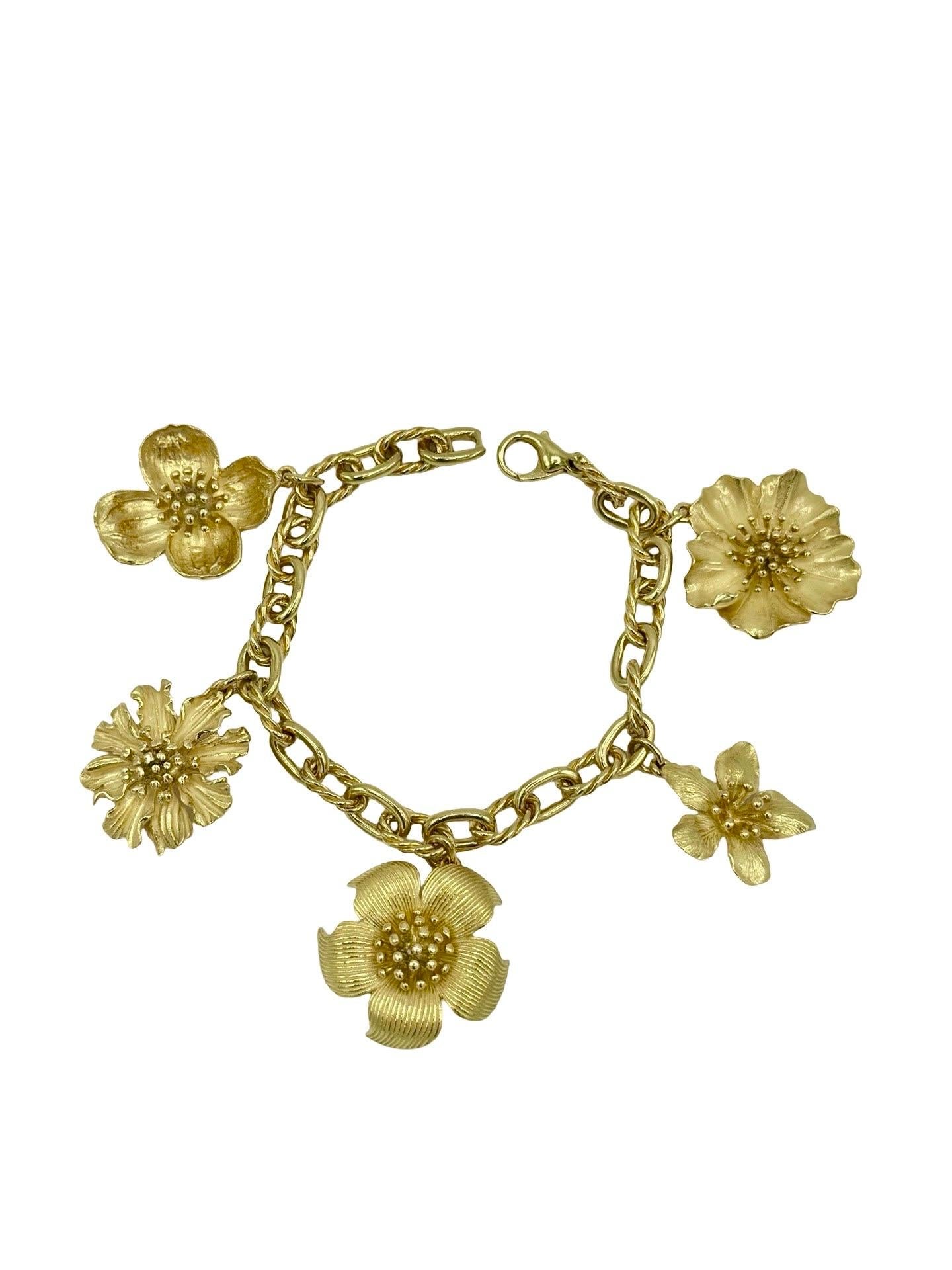 Questo eccezionale bracciale Tiffany & Co. è un pezzo raro della collezione Perennial Dogwood, splendidamente realizzato in oro giallo 18 carati. Il design presenta cinque ciondoli scultorei a forma di fiore di corniolo, ciascuno squisitamente