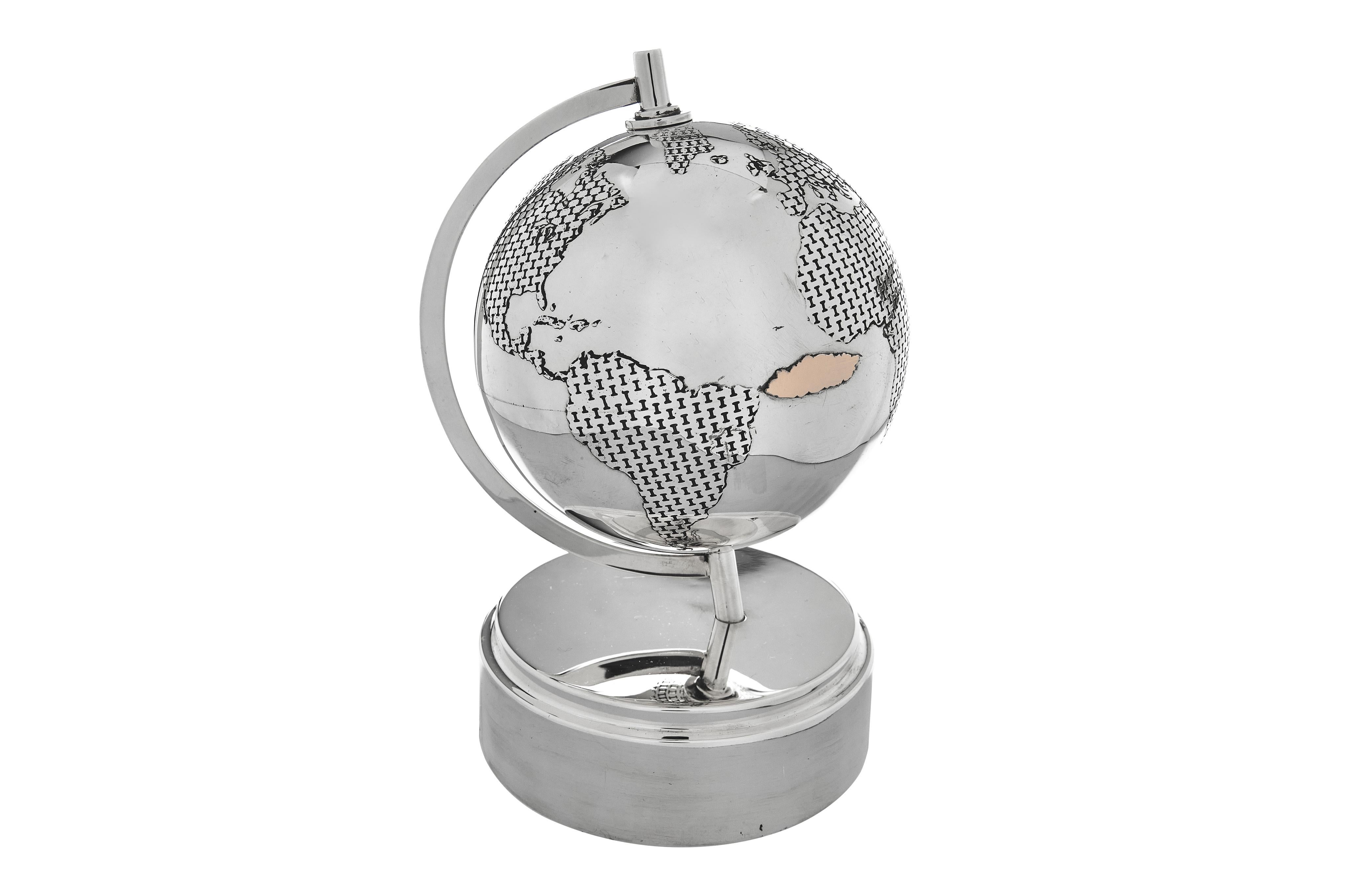 A rare and stunning Tiffany sterling globe. It has gold 