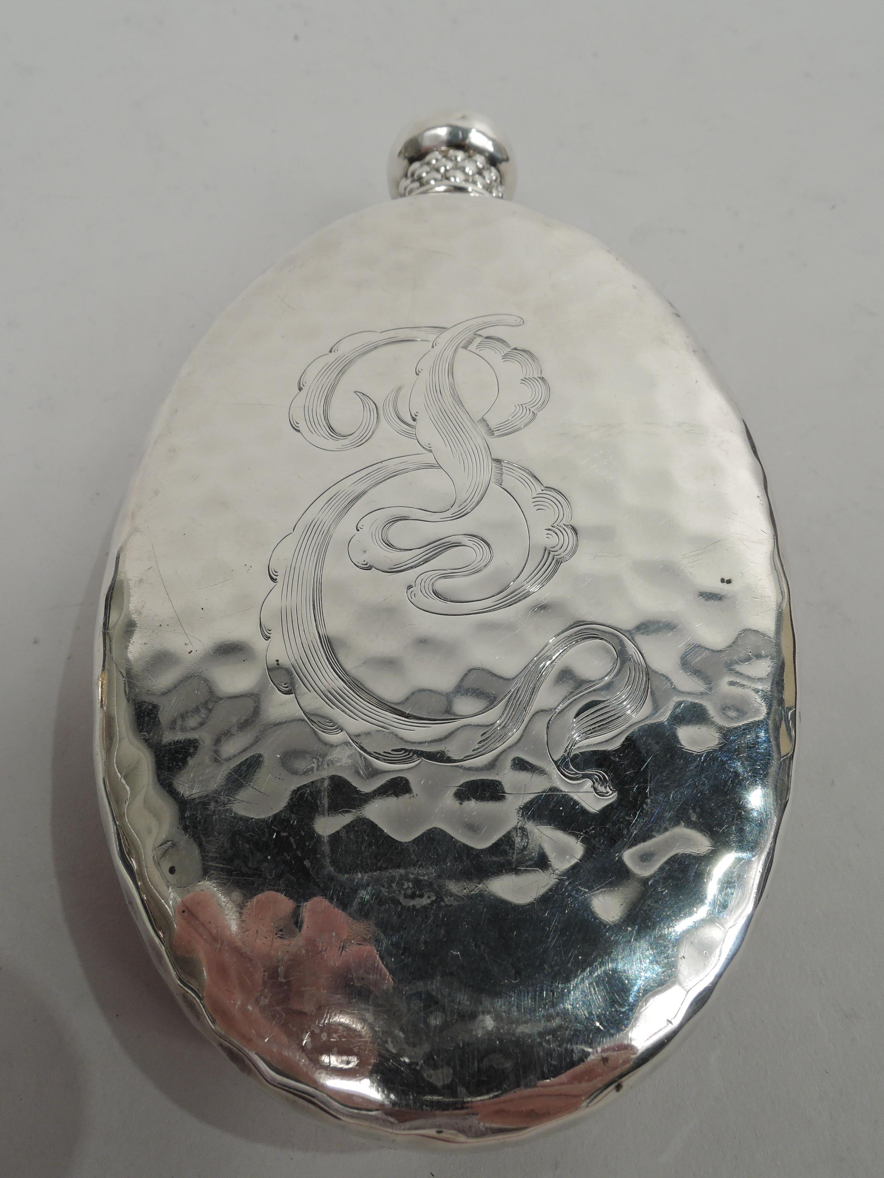 Rare sterling silver flask. Made by Tiffany & Co. in New York, ca 1882. Oval with curved sides and flat front and back. On front is seahorse with ribbed body and volute-scroll tail floating amongst seagrass. Back has stylistically integrated script