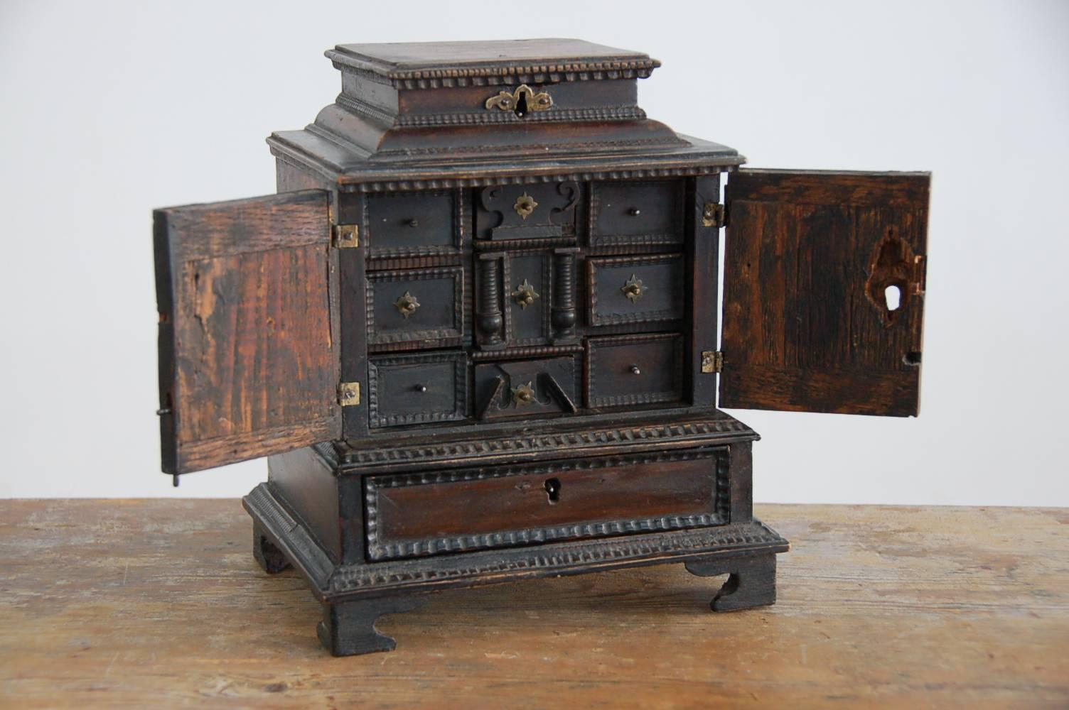 Remarkable 17th century tiny Baroque cabinet, origin: South Germany, circa 1680.

This miniature cabinet, which mimics the shape of full-size cabinets of the later seventeenth century, is a great rarity. The interior is fitted with ten small drawers