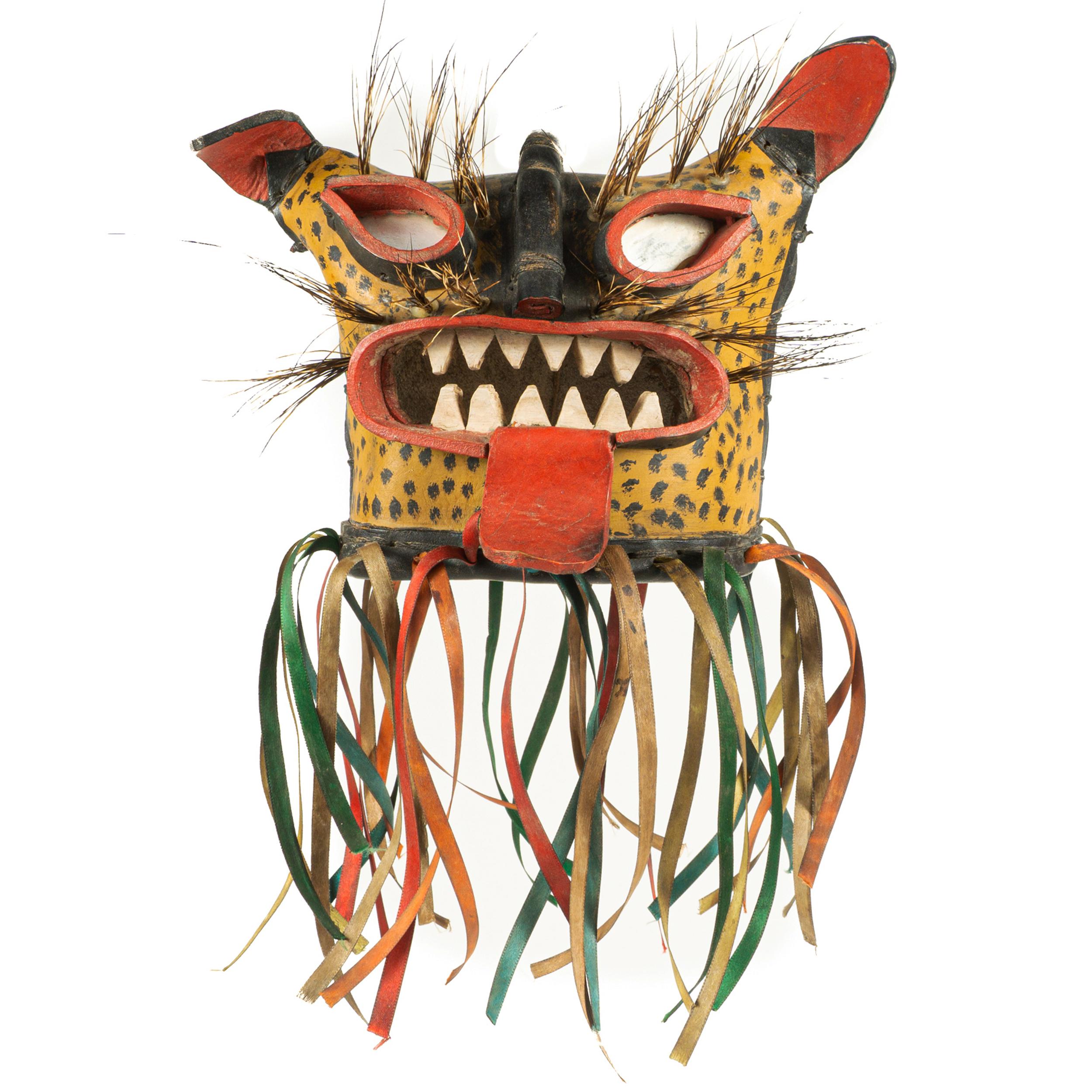 This style of Tigre (Mexican colloquial for Jaguar) mask is from Zitlala, Guerrero, they are used on the feast day of the Holy Cross on May 3rd, 4th,
and 5th. As part of the activities, men from different barrios put on jaguar costumes and carry