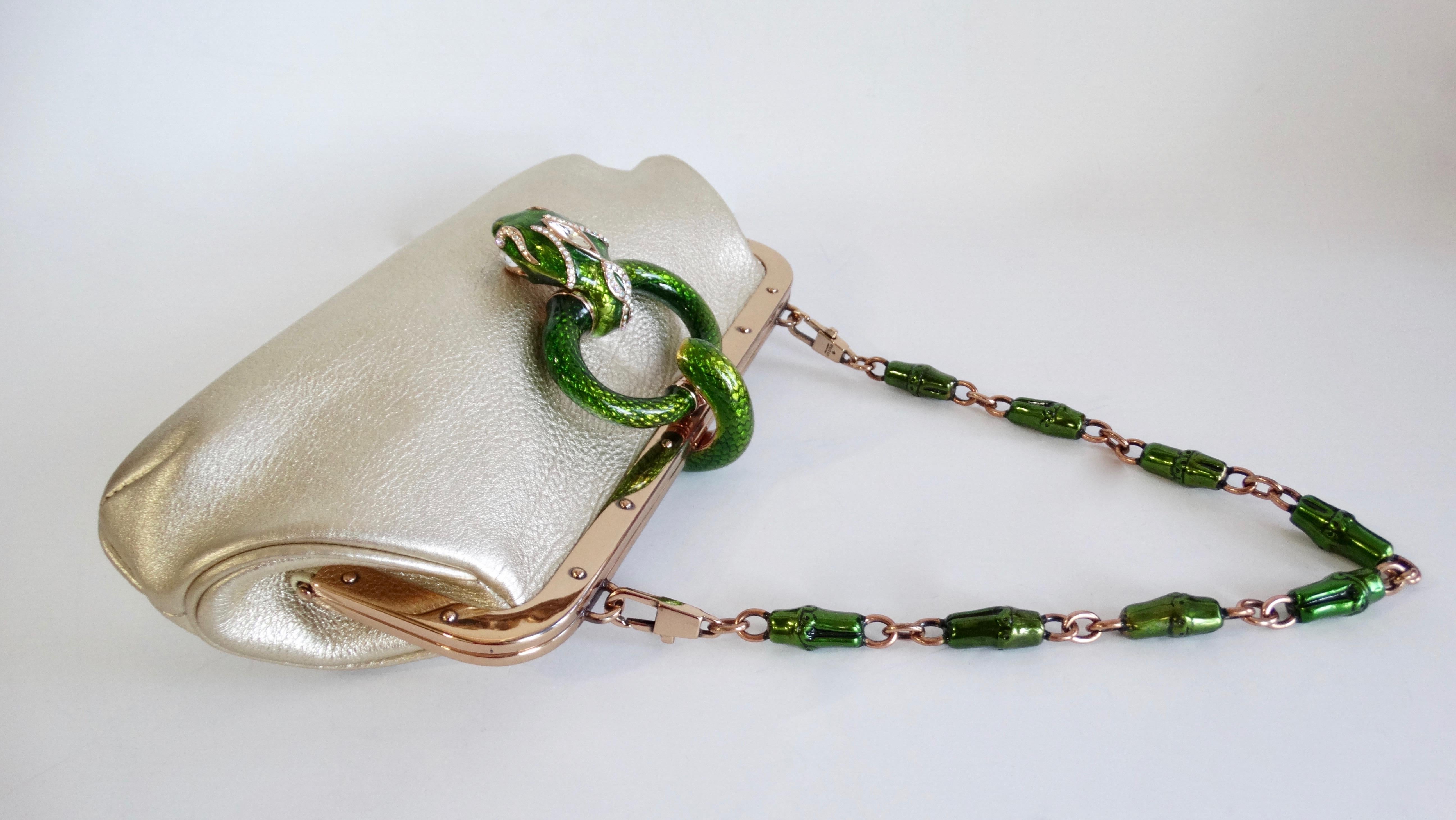 Show off with this rare Tom Ford for Gucci handbag/clutch! Circa 2004 from their S/S collection, this gold metallic pebble leather bag features gold hardware and a removable green enamel bamboo chain link strap. Includes a green enamel snake knocker