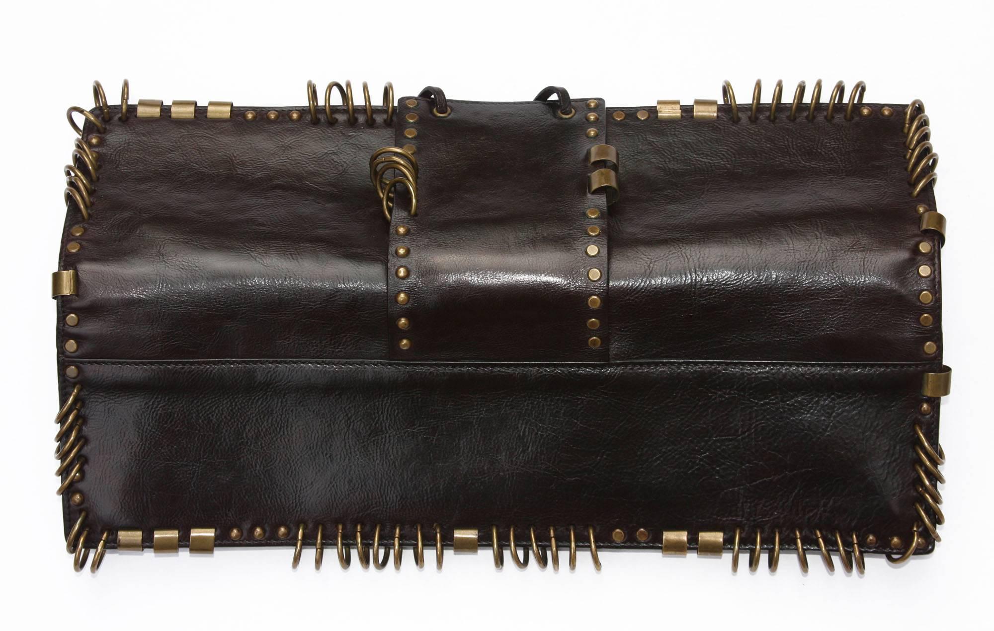 Very Rare dark brown leather clutch with brass hardware designed by Tom Ford for Yves Saint Laurent dating to Spring of 2002.
Measurements: L - 14 inches, H - 4 inches.
N 95928-000926
Excellent Condition.
Natural aged on brass hardware (easy to