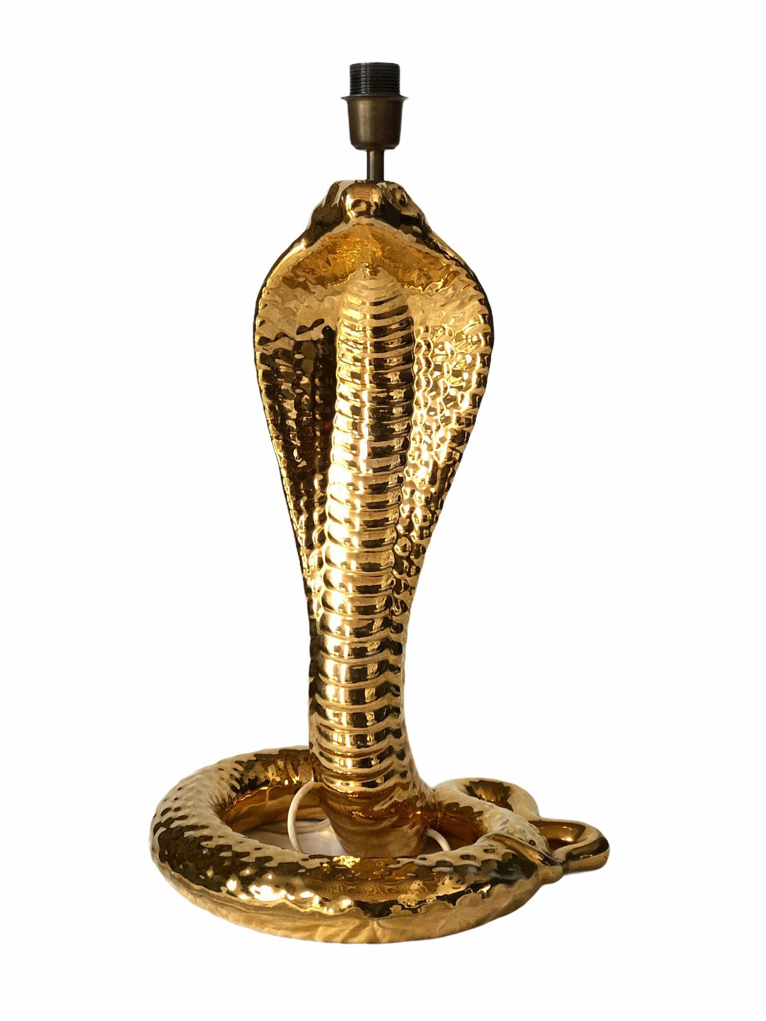 Rare Tommaso Barbi gold glazed ceramic majestic table lamp.

New wide white lamp shade with gold interior. 

Fully functioning lamp.

Minor sign of wear. No structural damage or chips. 

Measures: 55 cms cobra height
38 cms cobra base
Neck