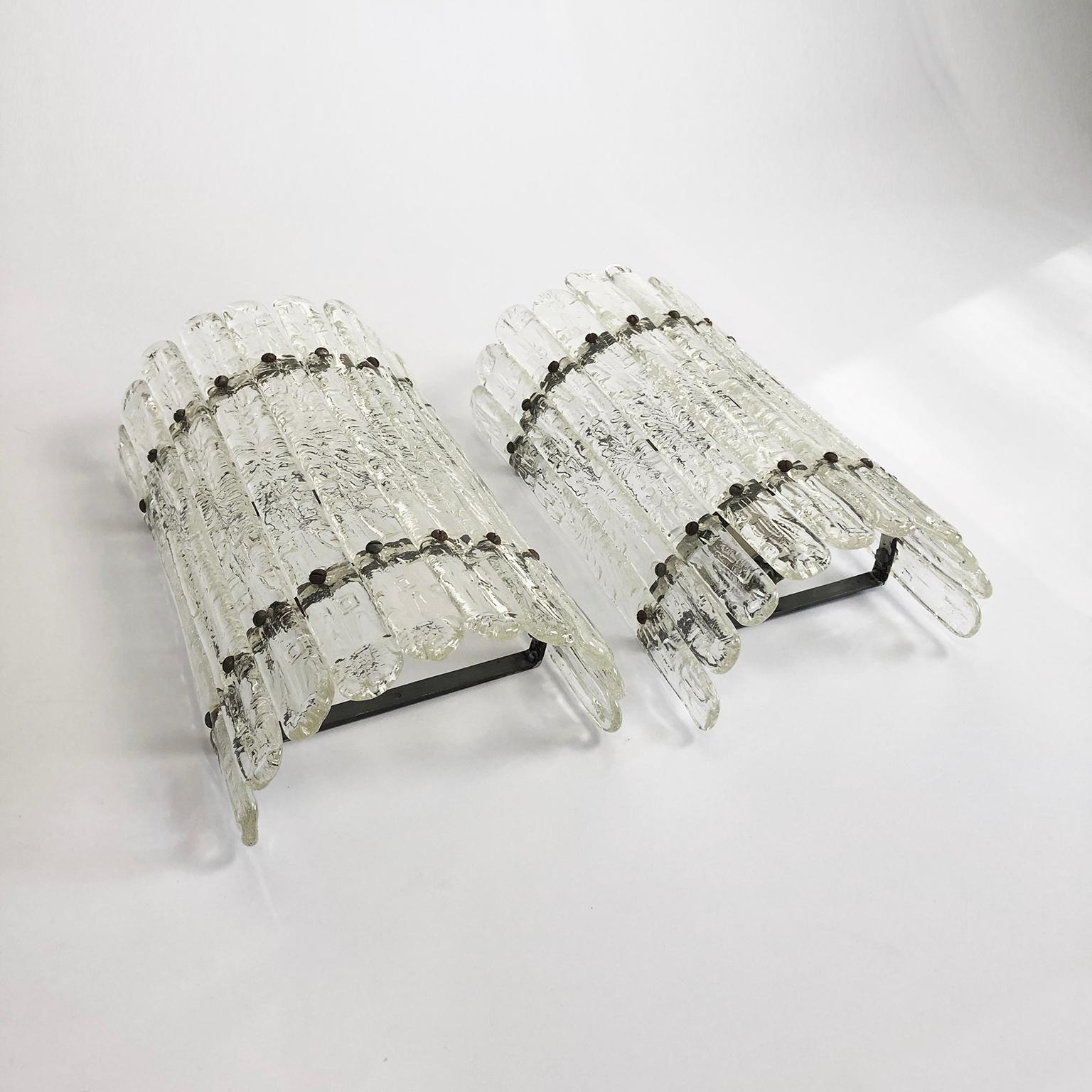 We offer this rare transparent pair of wall sconces designed by Felipe Delfinger, Feders, Cuernavaca, Mexico. Using recycled glass, circa 1970.