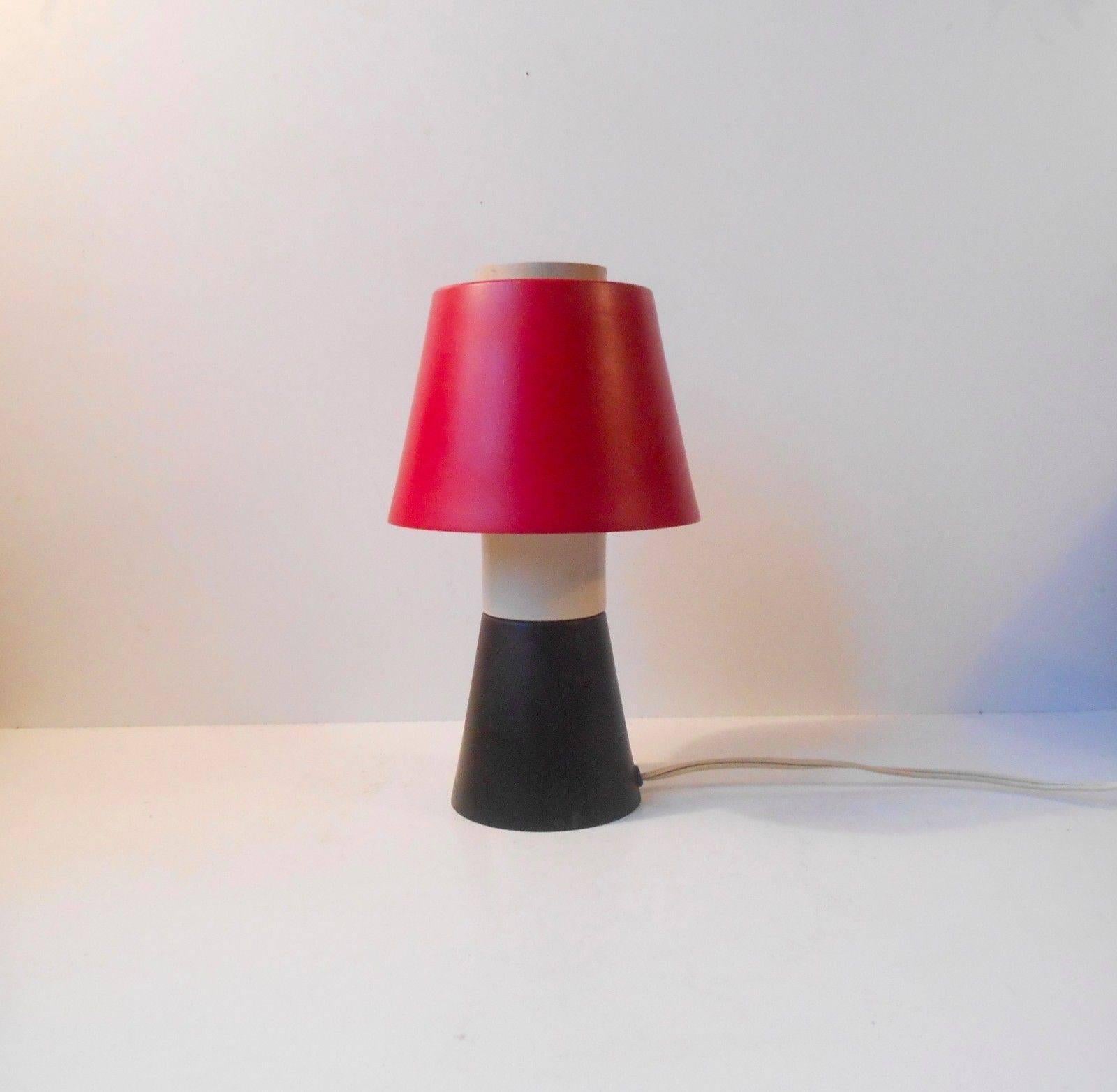 Measurements and info:

Type: Desk or table lamp.

Origin: Denmark.

Maker: Voss

Designer: Ernest Voss

Design period: early 1950s.

Height approx: 23 cm (9 inches).

Shade diameter: Approximate 16 cm (5.5 inches).

Material/color: Matte black, red