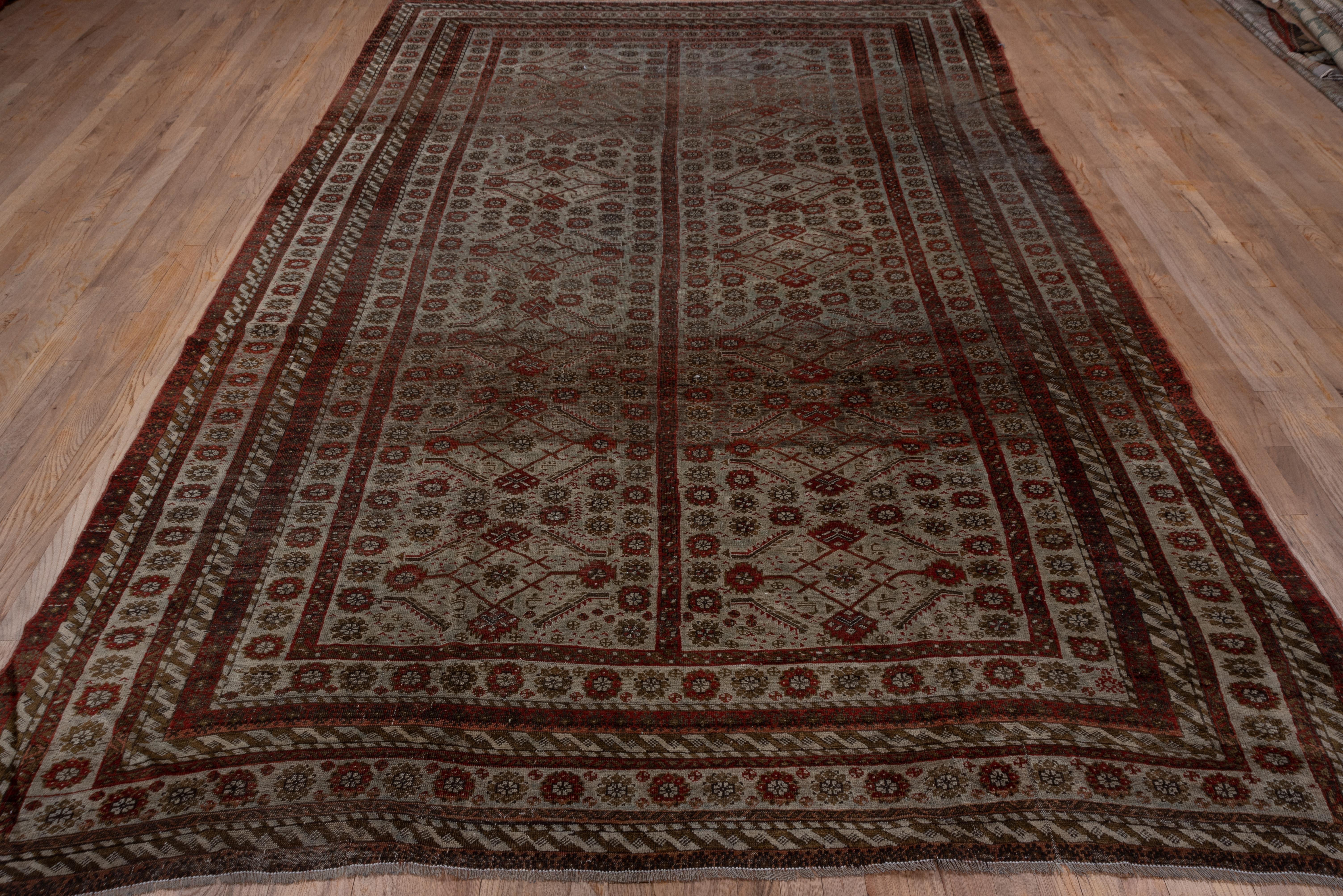 The two panel powder blue/cream field displays an abstract Herati pattern amid numerous octogramme rosettes and a few tiny animals. The borders show similar rosettes and interlocking slanted 's' designs on this NE Persian nomadic carpet.