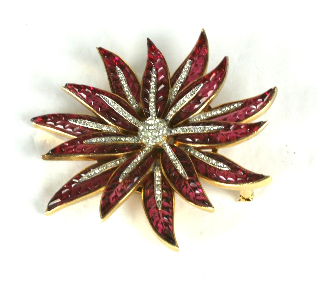 Super Rare Trifari Alfred Philippe Pave and Invisibly Set Faux Ruby Poinsettia Star Flower Pin of gold plated base metal, rhinestones, faux invisibly set rubies. 
Marked: Trifari with Crown. Condition: Excellent
Size: 2.85