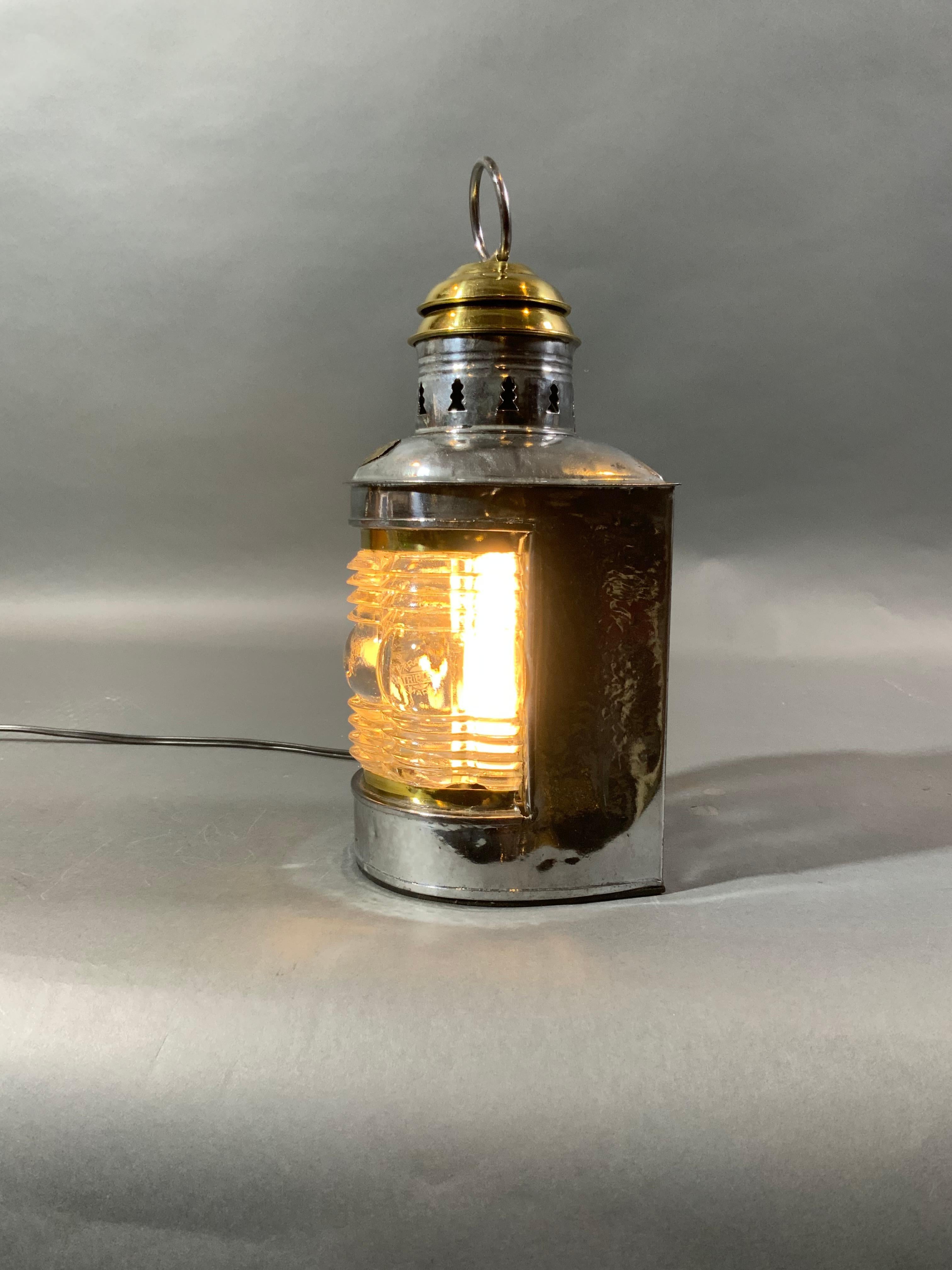 Nice masthead lantern by Triplex. Polished steel case with vented brass top. Lantern has the rare rippled Fresnel glass lens. Unit has been electrified for home use. Lantern has been lacquered. Weight is 3 pounds. Dimensions are 11 tall by 5 by 5.