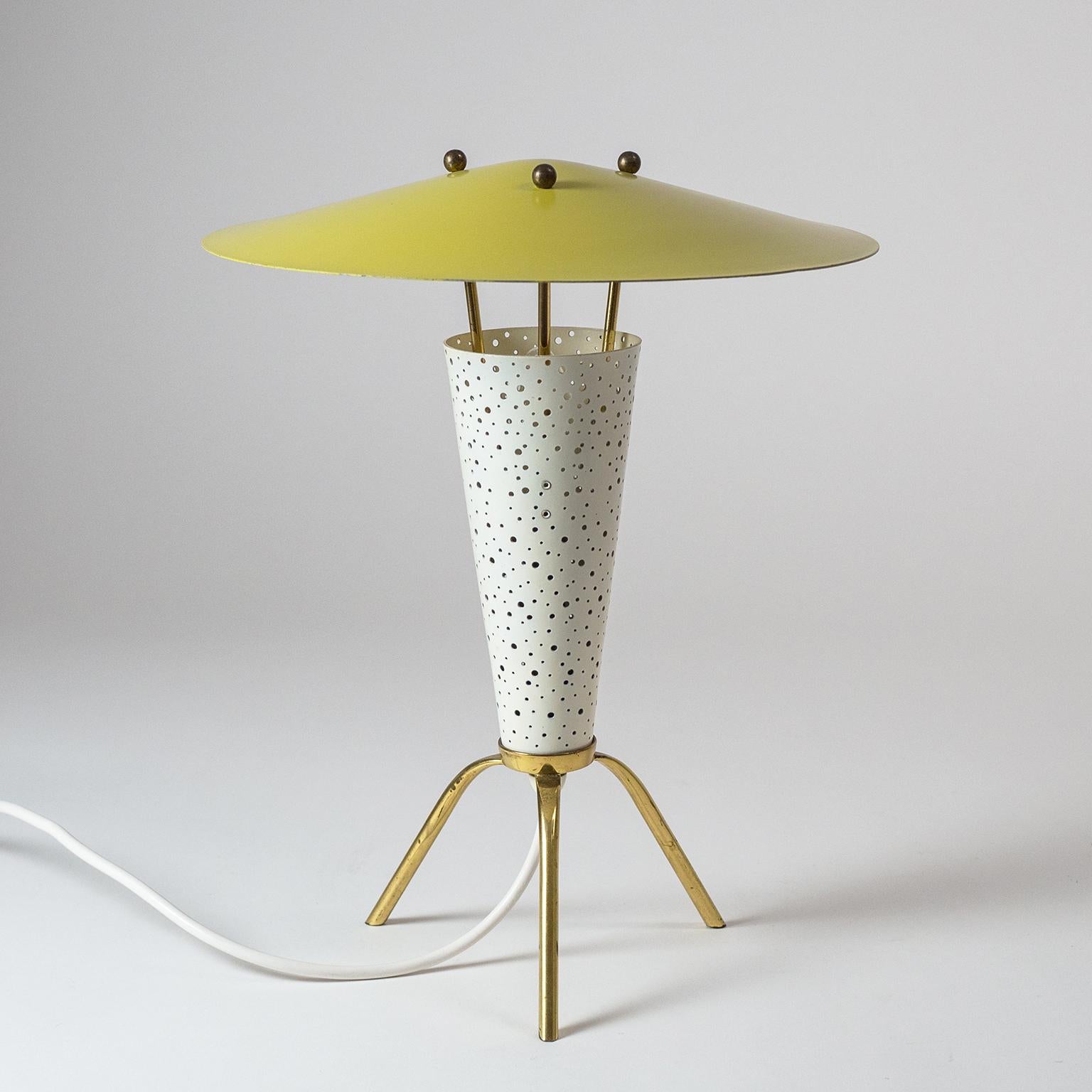 Delightful Mid-Century tripod table or desk lamp attributed to Ernest Igl. His trademark use of perforations of varying size is taken to the extreme in this gem of a table lamp. The light effect is simply spell binding and even when switched of the