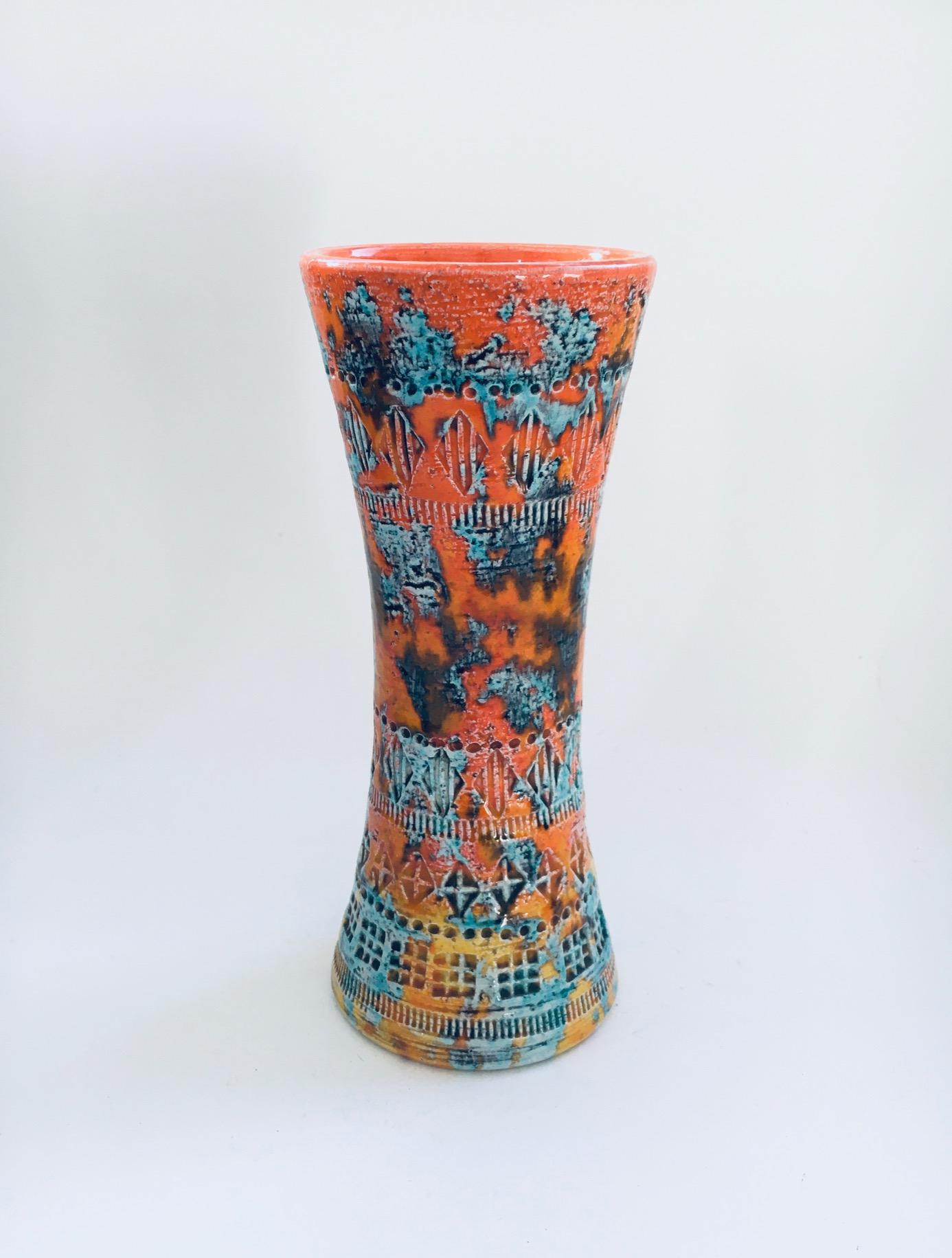 Vintage Art Ceramics Rare Trumpet Vase in Sunset Glaze by Aldo Londi for Bitossi. Made in Italy, 1960's period. Orange Yellow underglazes with greenish over glazes and the typical to Bitossi geometric stamped shapes. Marked on the bottom. This comes