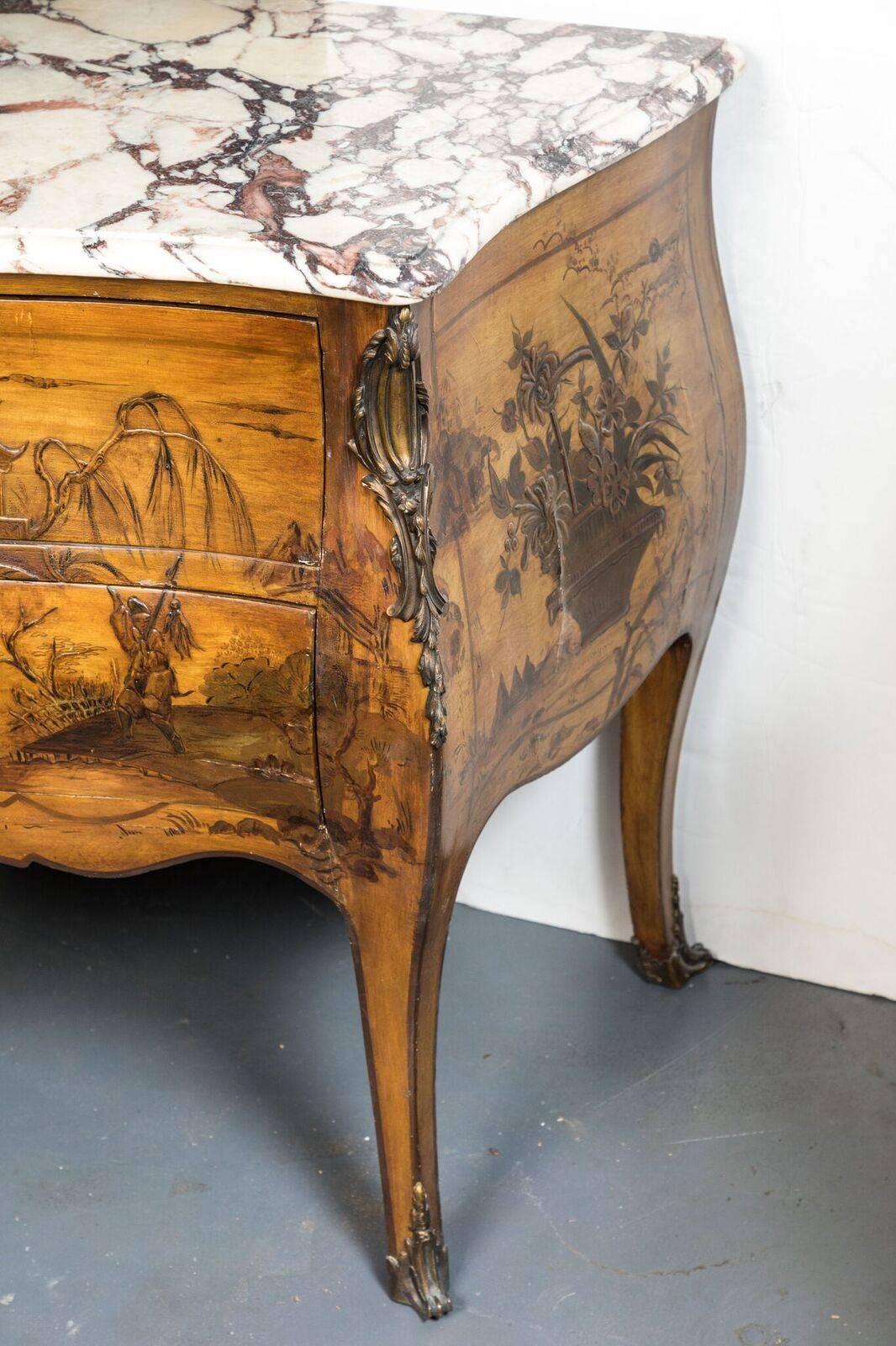 Remarkable pair of nearly identical, hand-painted and lacquered, saffron-hued, two-drawer, Bombay style marble-top commodes with ormolu mounts atop cabriole legs.