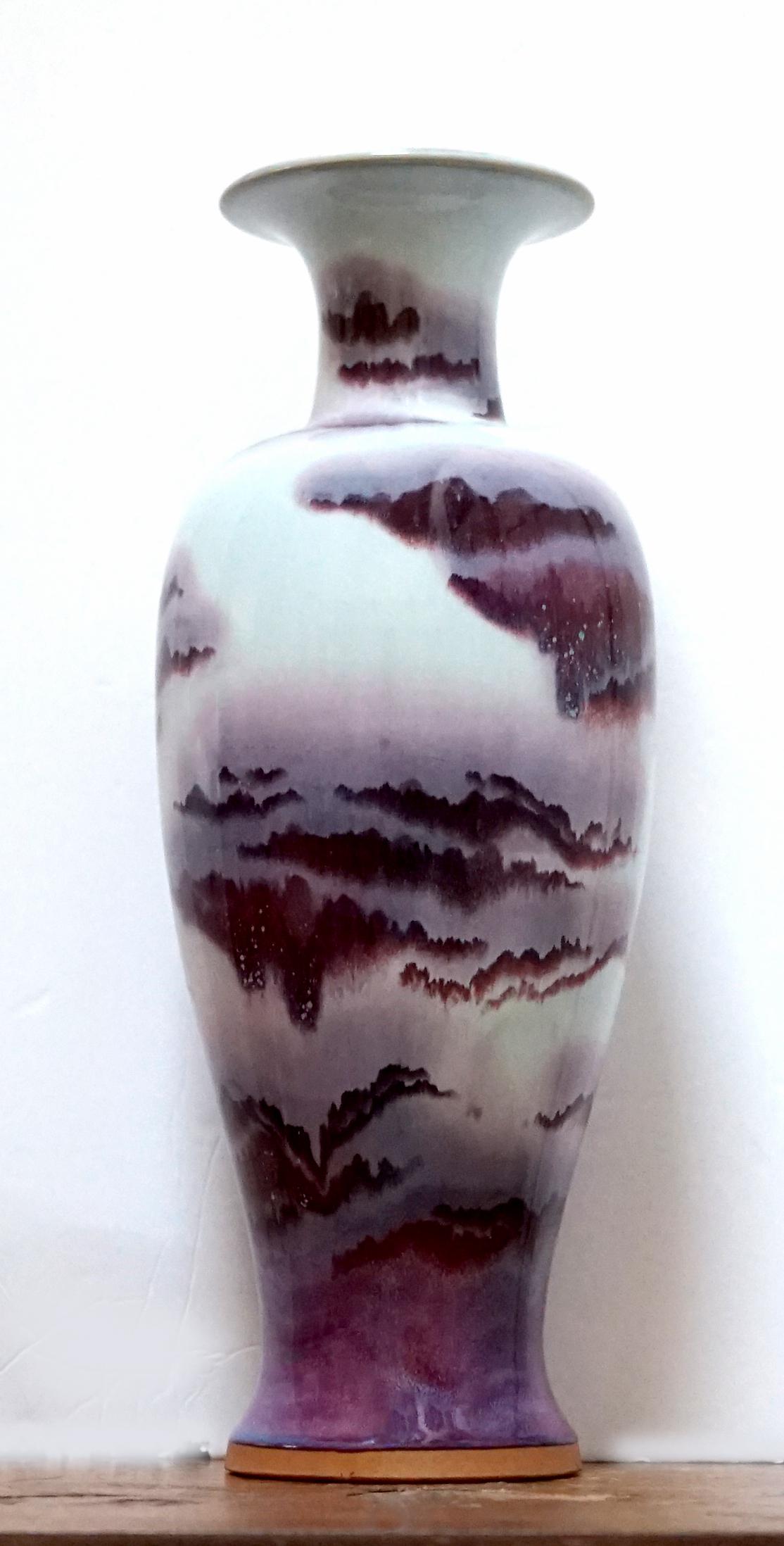 The color and formation on this vase is stunning. A 19th century Chinese Sang de Boeuf blue and red toned vase. The Sang de boeuf vase features a rich, deep red glaze that ranges from a dark, almost purplish hue to a lighter, translucent red and