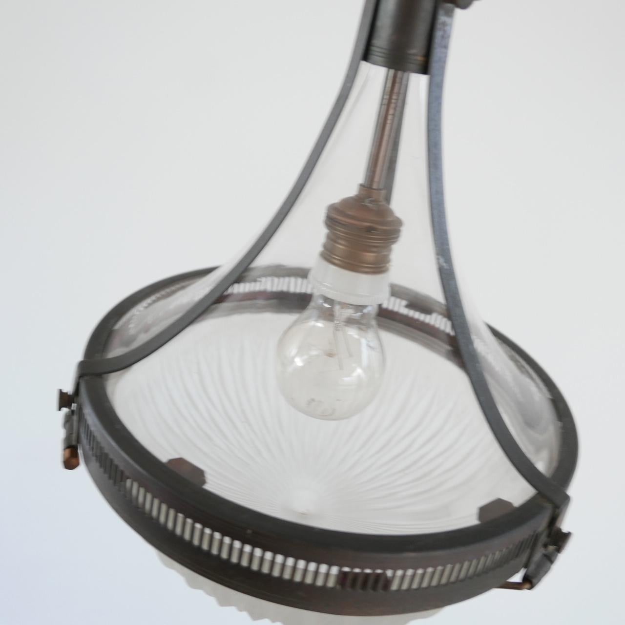 An incredibly rare model early 20th century pendant light, likely German.

Unusual clear blown glass top, with a cut glass etched bottom encased in a bronze gallery. 

Highly decorative and contemporary, originating from circa 1910. 

The only