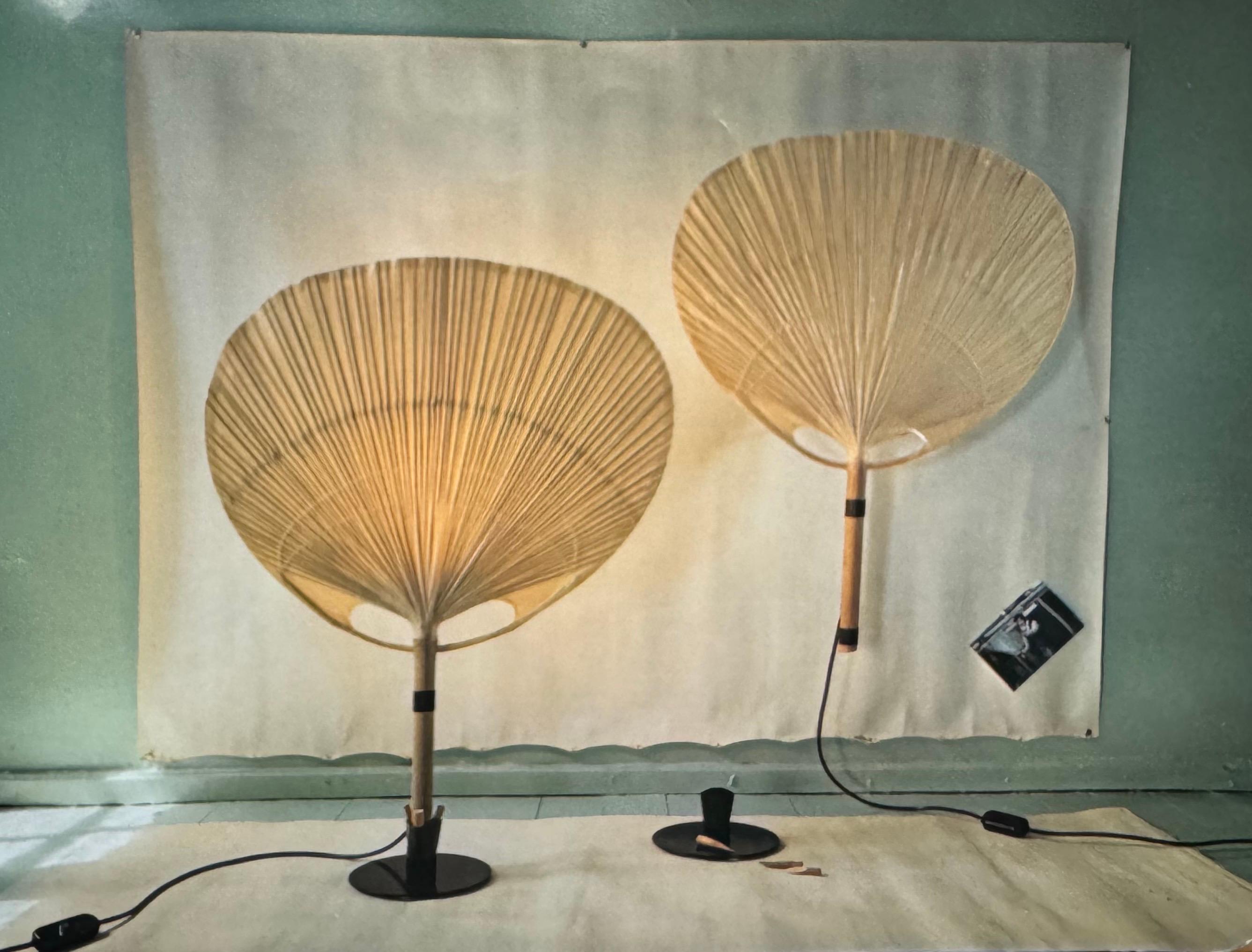 Rare table lamp by Ingo Maurer for Design M, 1970s, Germany. Executed in bamboo, rice paper fan and black lacquered iron.
Socket: 1 x E27 or E26 (US)  for standard screw bulbs.
(Pair available).