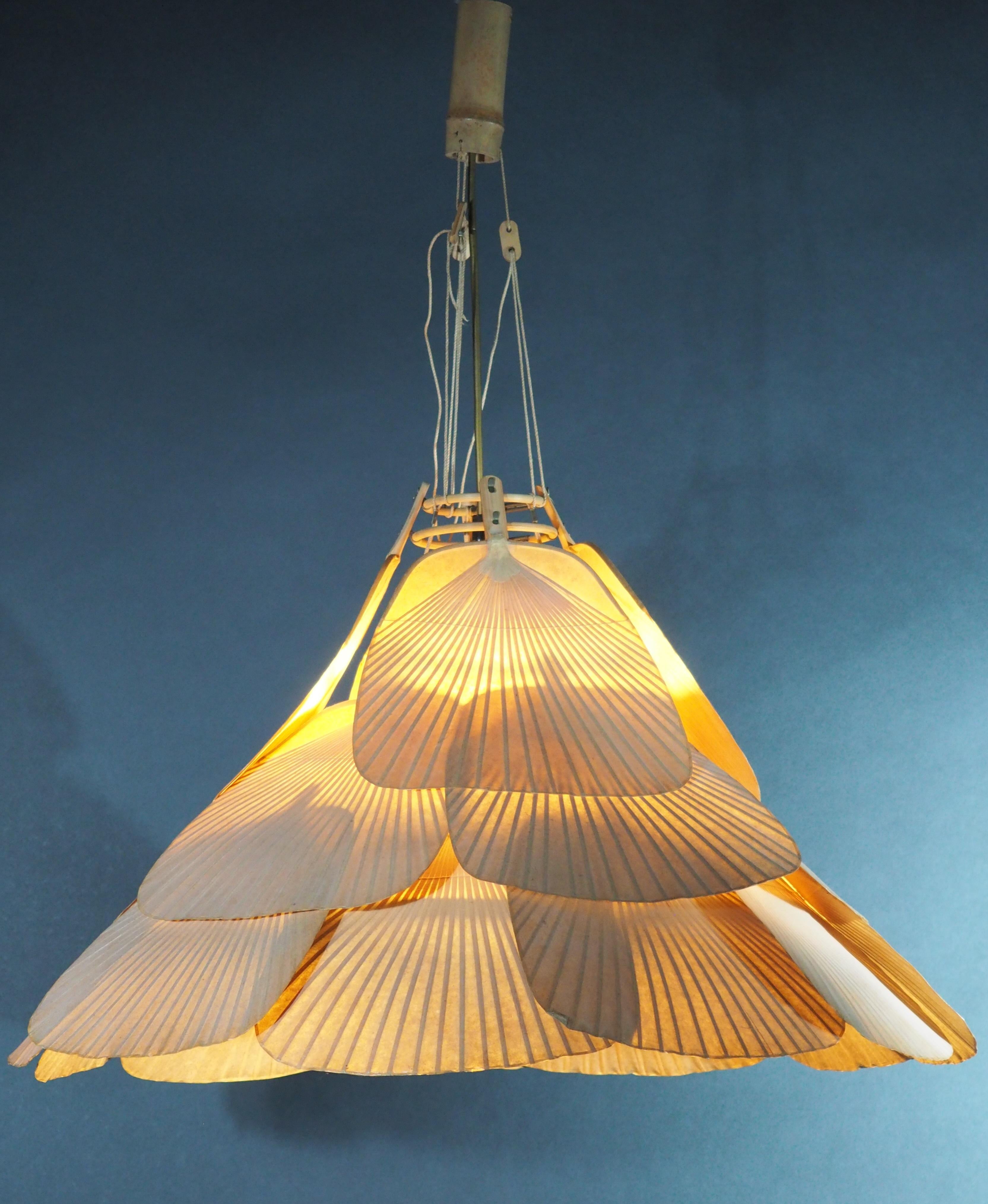 An exceptional Uchiwa bamboo fan chandelier or pendant lamp by Ingo Maurer for Design M, 1970s, Germany. Executed in bamboo and 21 rice paper fans.
Socket: 1 x E27 Edison for standard screw bulbs.
Height adjustable by suspension from 3