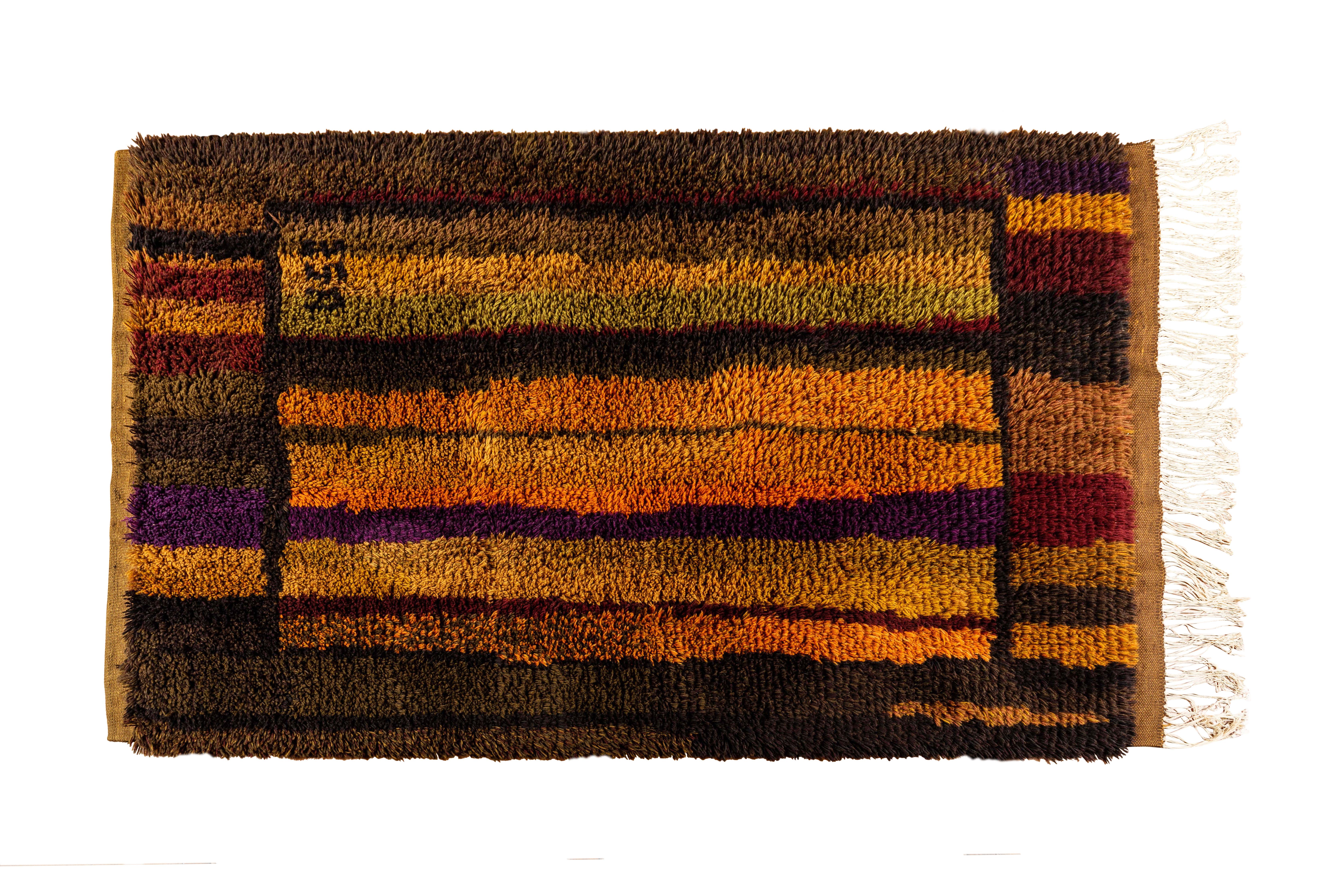 Rare Uhra Beata Simberg-Ehrström 'Ruska' Finnish rug, circa 1968. A stunning geometric rug executed in handwoven wool celebrating the colors of autumn. Rich texture and modern abstract lines artfully woven into the high pile. Measures 68 inches long
