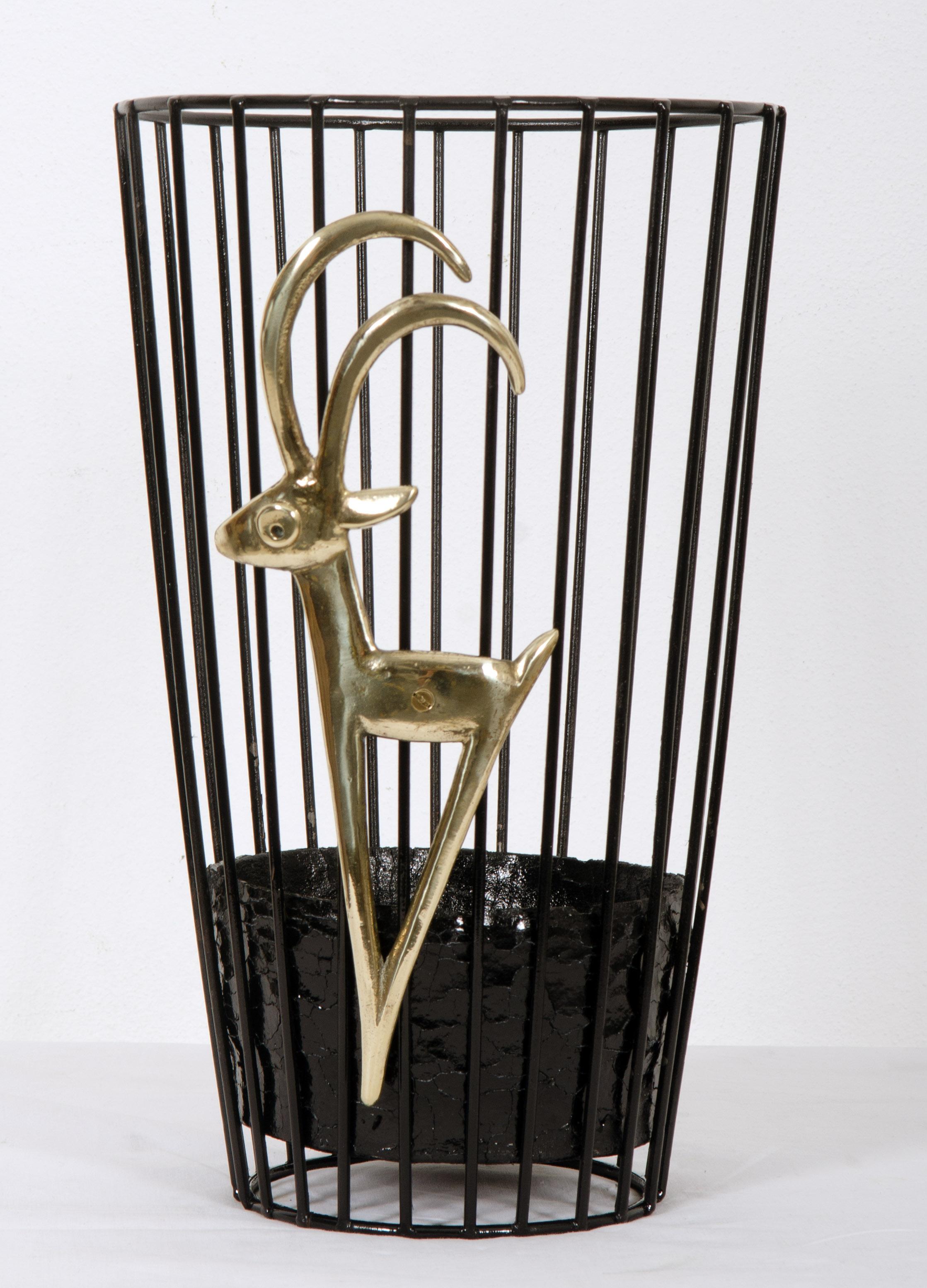 Steel basket with lead casting drip tray black painted with a brass capricorn outside the basket, designed by Walter Bosse in the 1950s for Hertha Baller. 
  