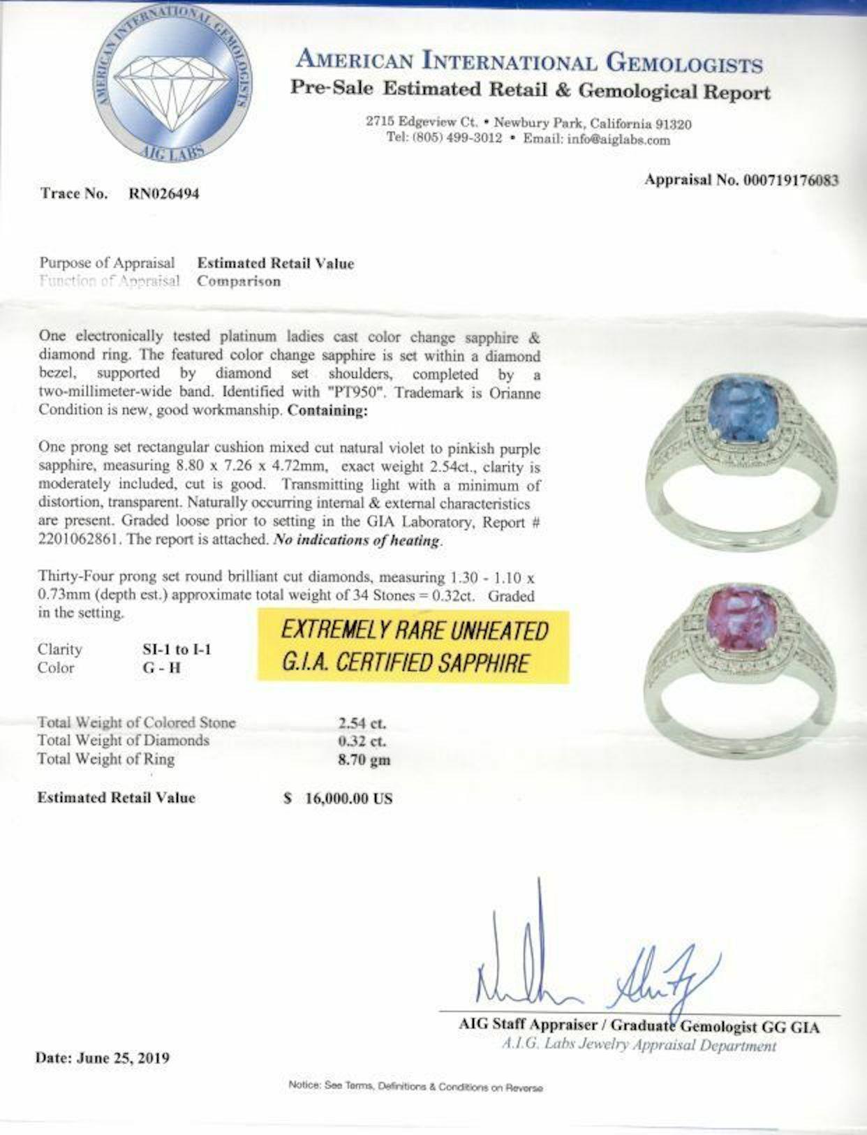 Orianne Sapphire & Diamond Ring
Style:  Diamond Halo with Split Shank Ring
Metal:  Platinum
Size / Measurements:  Ring size 7
TCW:  2.86 Carats Total
Main Stone:  Cushion Cut Color Change Sapphire
Color & Treatment:  Violet changing to Purplish