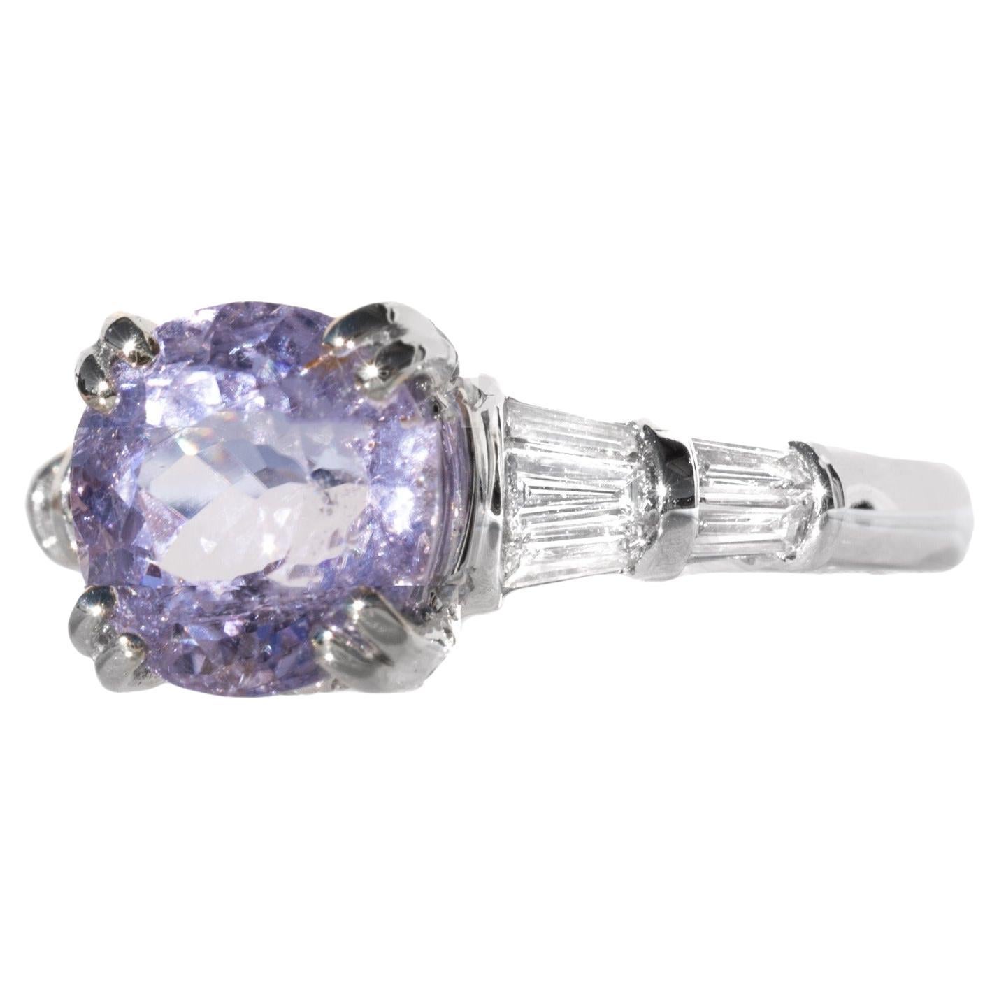 This is one of the rarest and most sought-after gemstones - and one of the most beautiful! This gemstone is a beautiful lavender sapphire. The color is exceptional, with hot pink sparkle. We put this ring in one of our most stunning designer