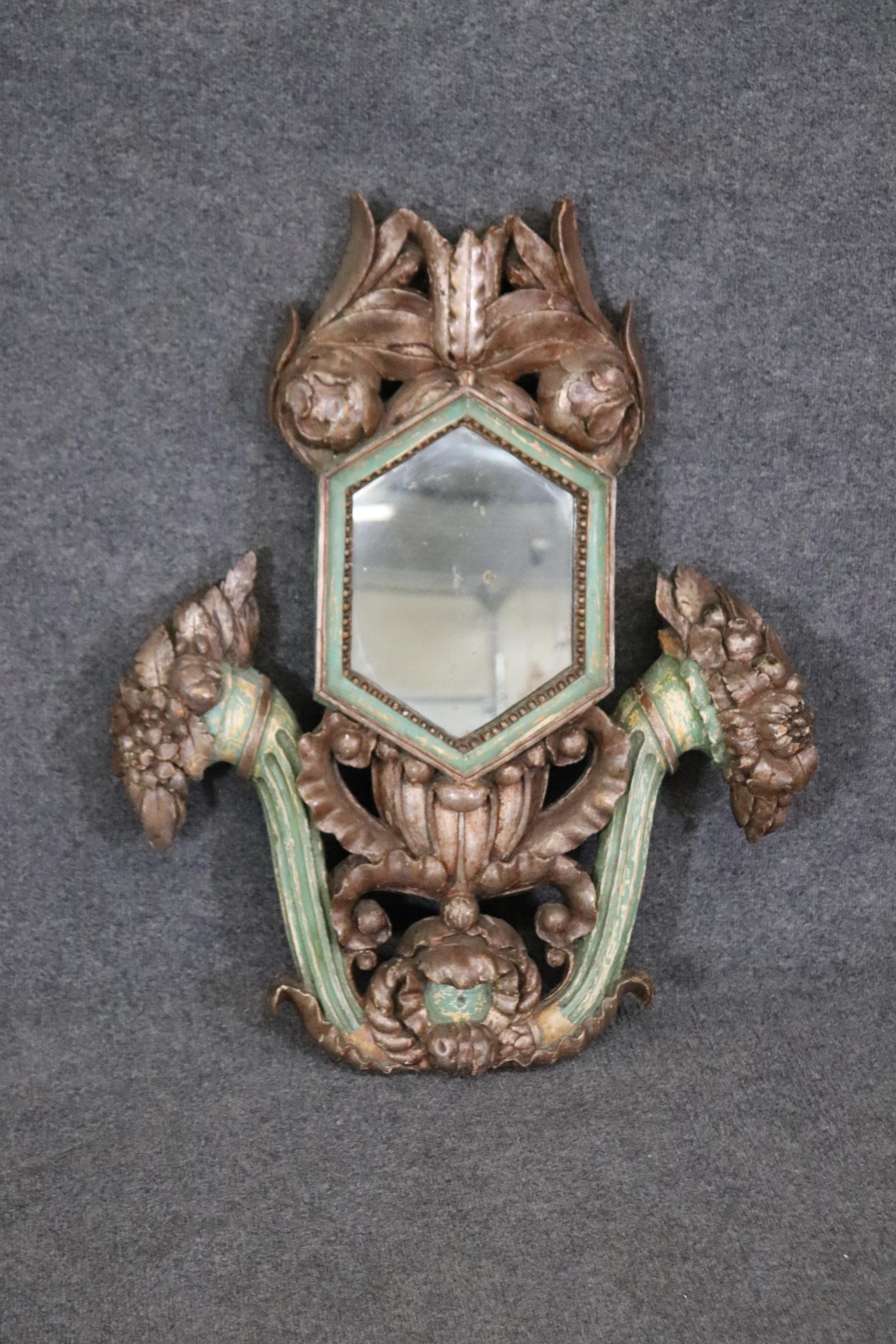 This is a gorgeous and unique French mirror with a polychromed paint decorated frame and gilding as well. The mirror is original and will show patina of the silvering backing. Measures 31.75 tall x 26 wide x 3.75 thick and dates to the 1860s era. 