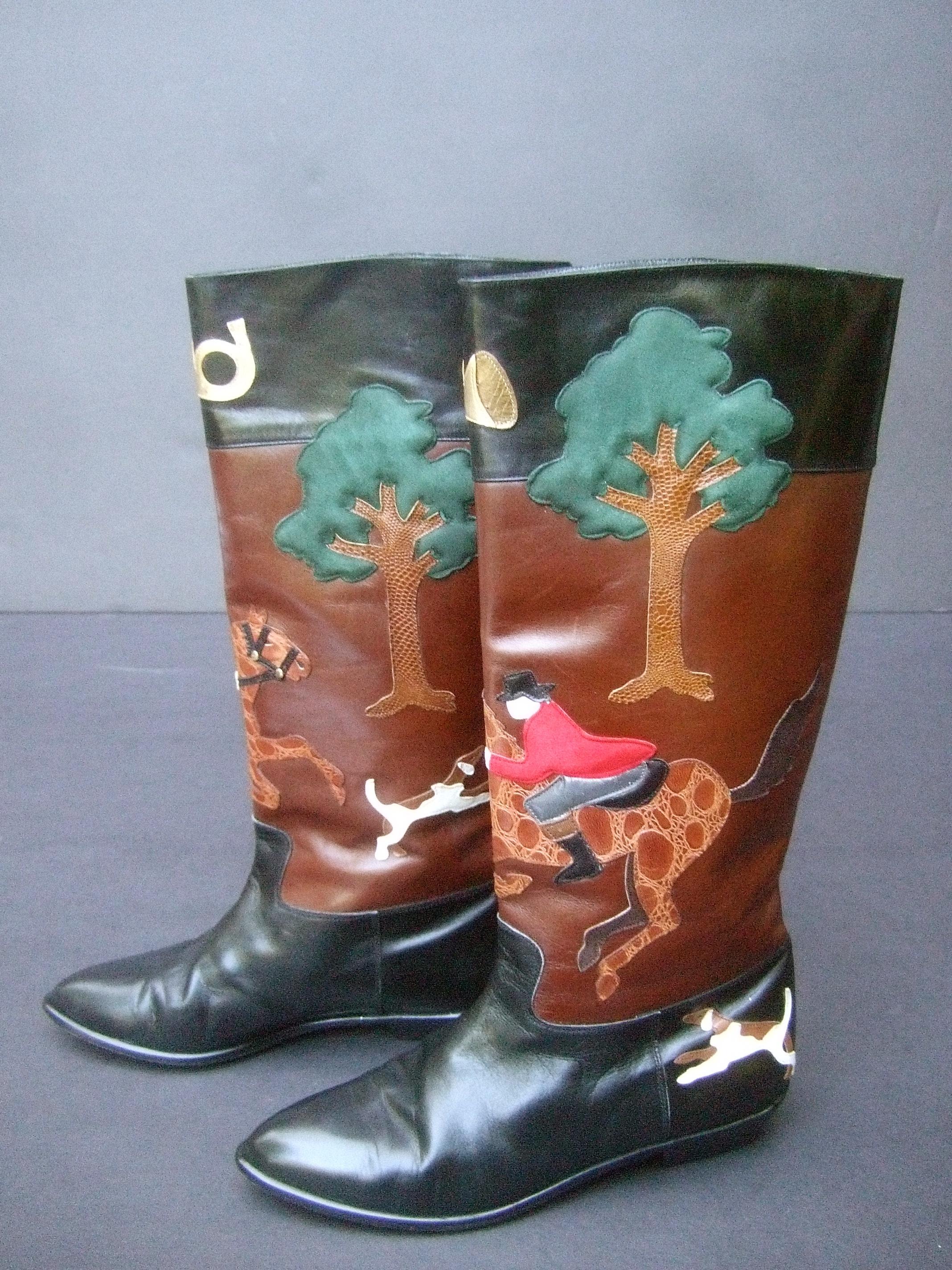 Rare unique hunt scene leather & suede applique boots designed by Beverly Feldman c 1990
The stylish black & brown leather boots depict a pair of hunters wearing red suede jackets;
mounted on brown embossed applique leather horses; surrounded by