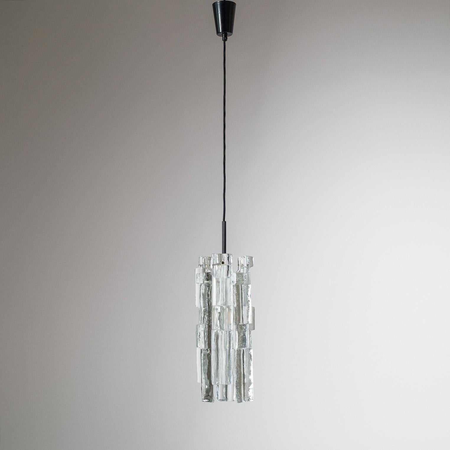 Exceptional Kalmar pendants from the 1960-1970s. Each pendant consists of six heavily textured Brutalist glass 'blocks' that are mounted around an E27 socket (60W). The glass is clear, however due to its thickness and heavy texture it will catch the