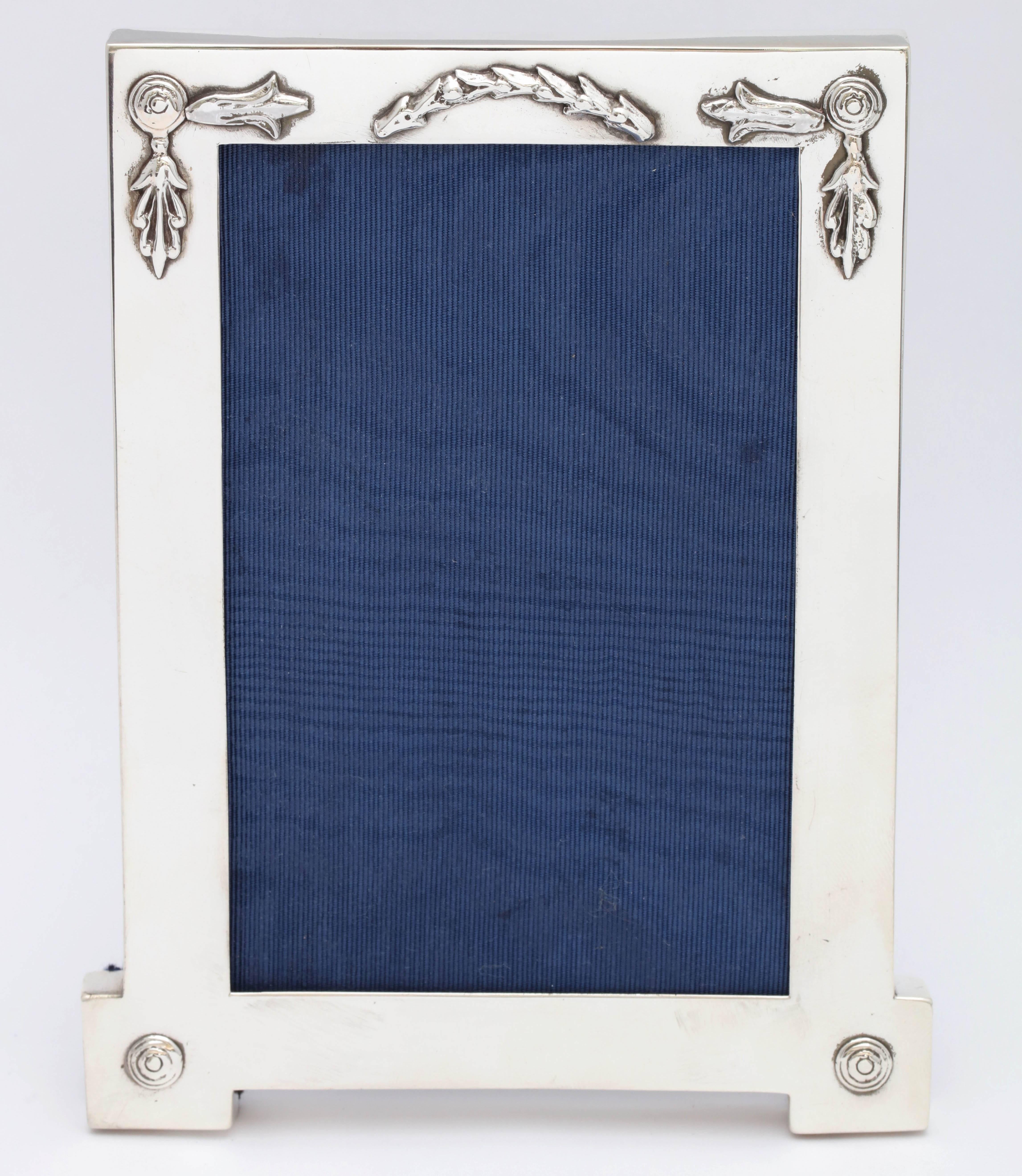 Rare, unusual, Edwardian, sterling silver, footed picture frame, London, 1909. Measures 6 1/2 inches high x 5 inches wide at widest point x 4 inches deep when easel is in open position. Holds a photo that measures 4 inches x 6 inches; window will