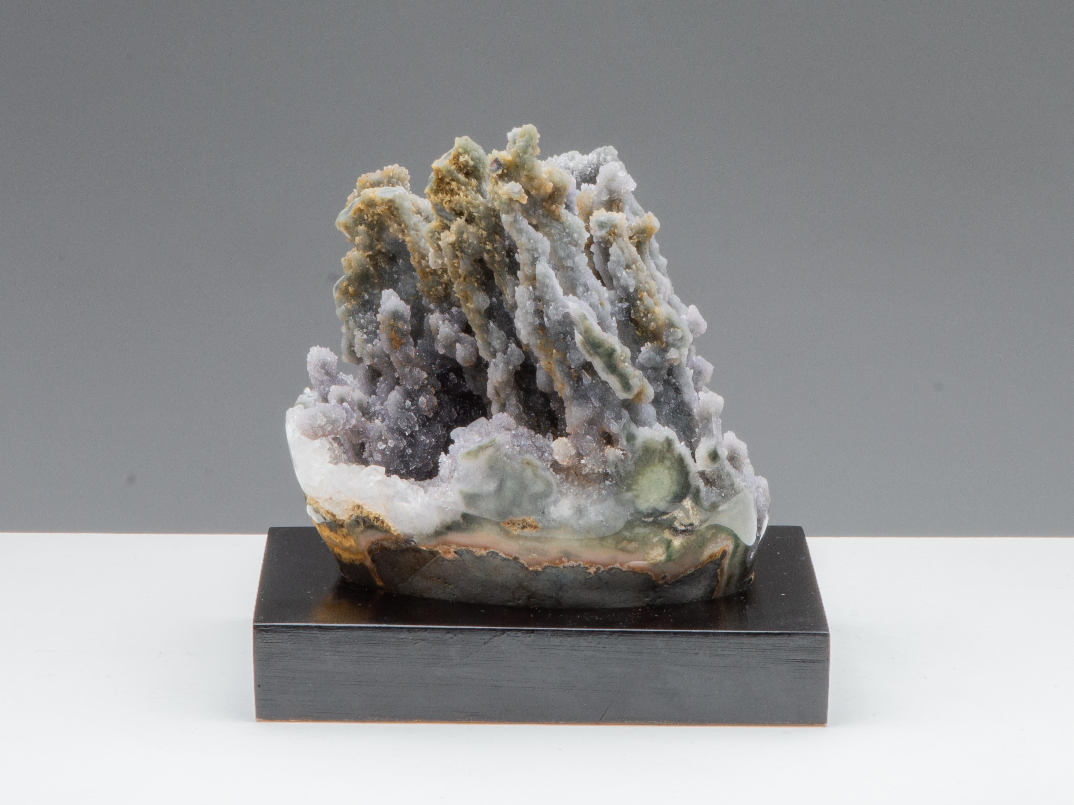 An unusual mineral formation of organic appearance. This piece is composed of light grey to green druze, with beautiful multiple stalactite formations and a blanket of white quartz.

The edges of this beautiful mineralogical piece have been