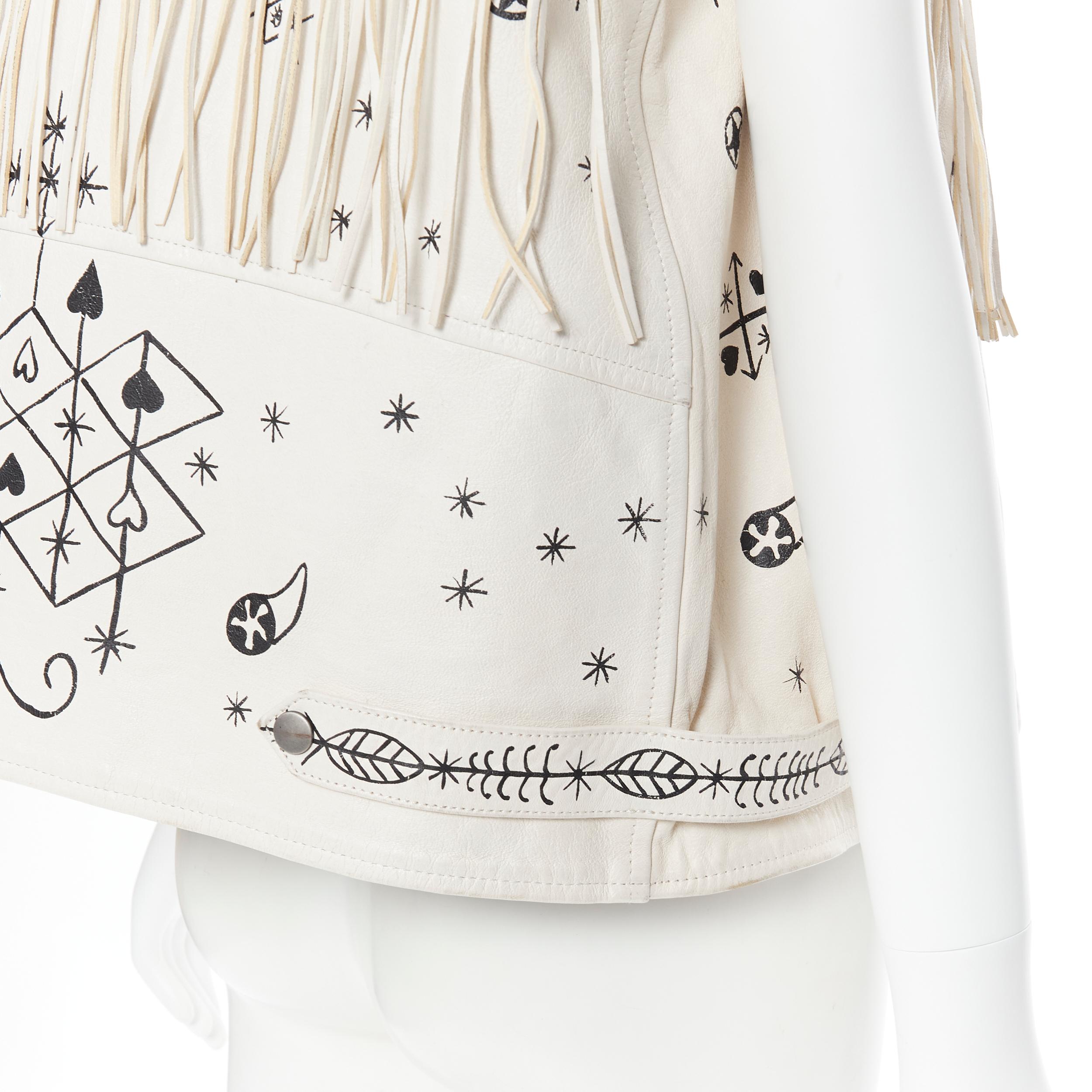rare VALENTINO beige black horoscope scribble fringe leather biker vest IT38 XS 
Reference: TGAS/B00120 
Brand: Valentino 
Material: Leather 
Color: Beige 
Pattern: Abstract 
Closure: Zip 
Extra Detail: Beige leather upper. Black illustration