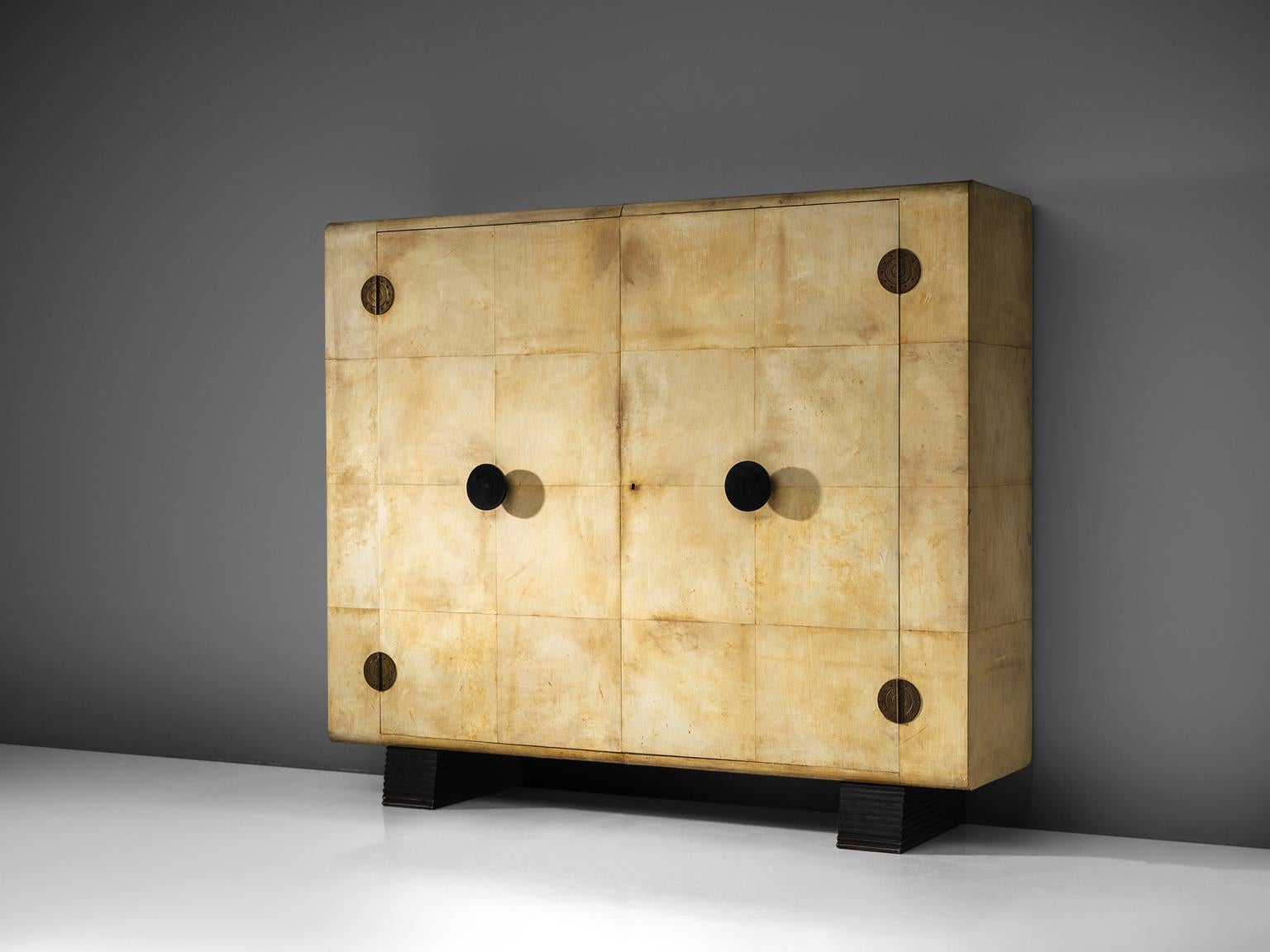 Valzania, armoire made in parchment, brass, mahogany and ebonized wood, Italy, circa 1935.

This grand wardrobe made with parchment, is a unique piece, both in its design and in the use of material. The piece in this exquisite condition and size