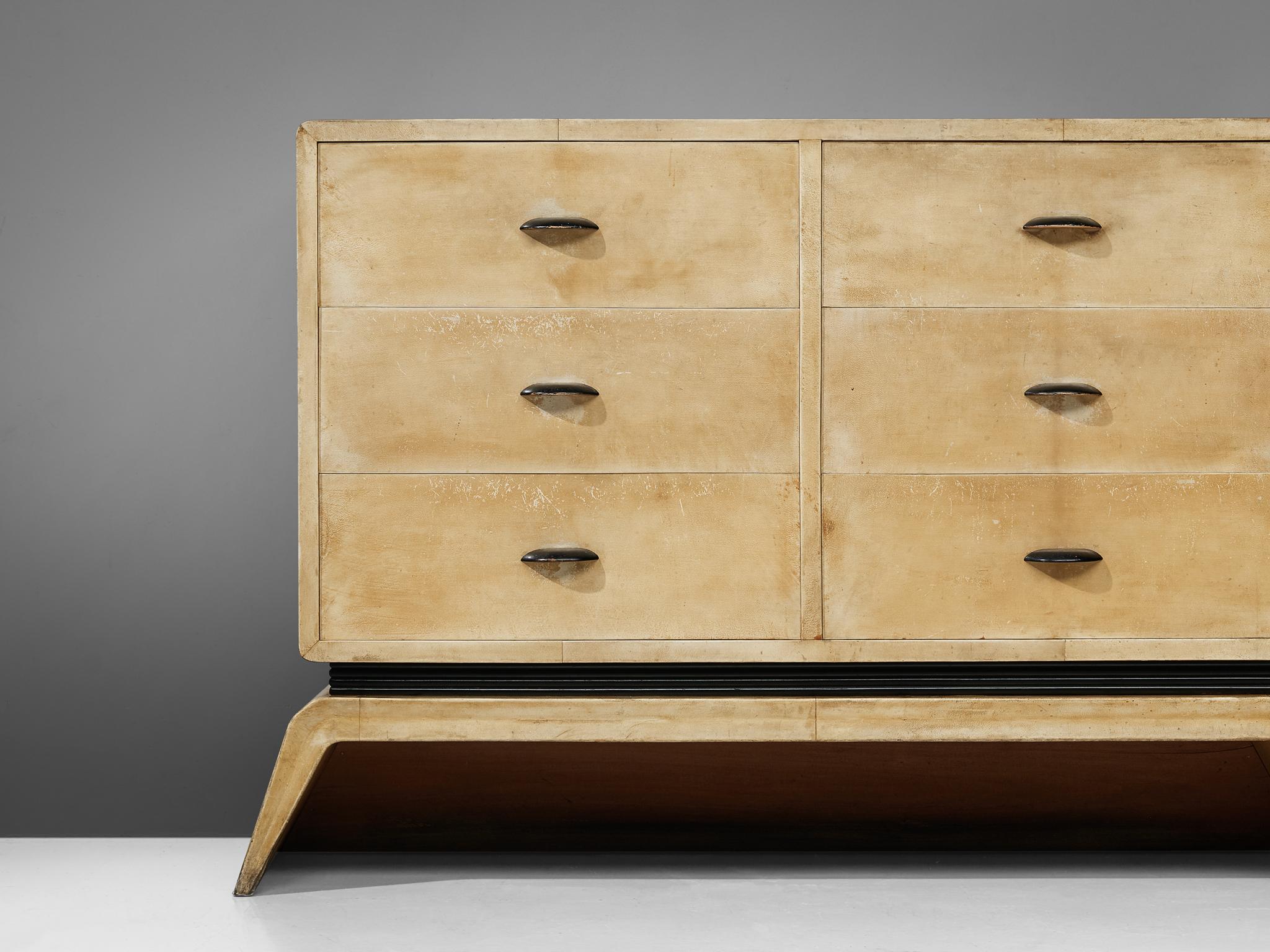 Valzania, sideboard, parchment, ebonized wood, Italy, 1940s

Rare sideboard with six drawers designed and created by Valzania in the 1940s. The sideboard is fully covered in a light parchment with a beautiful patina. The cabinets are lifted by