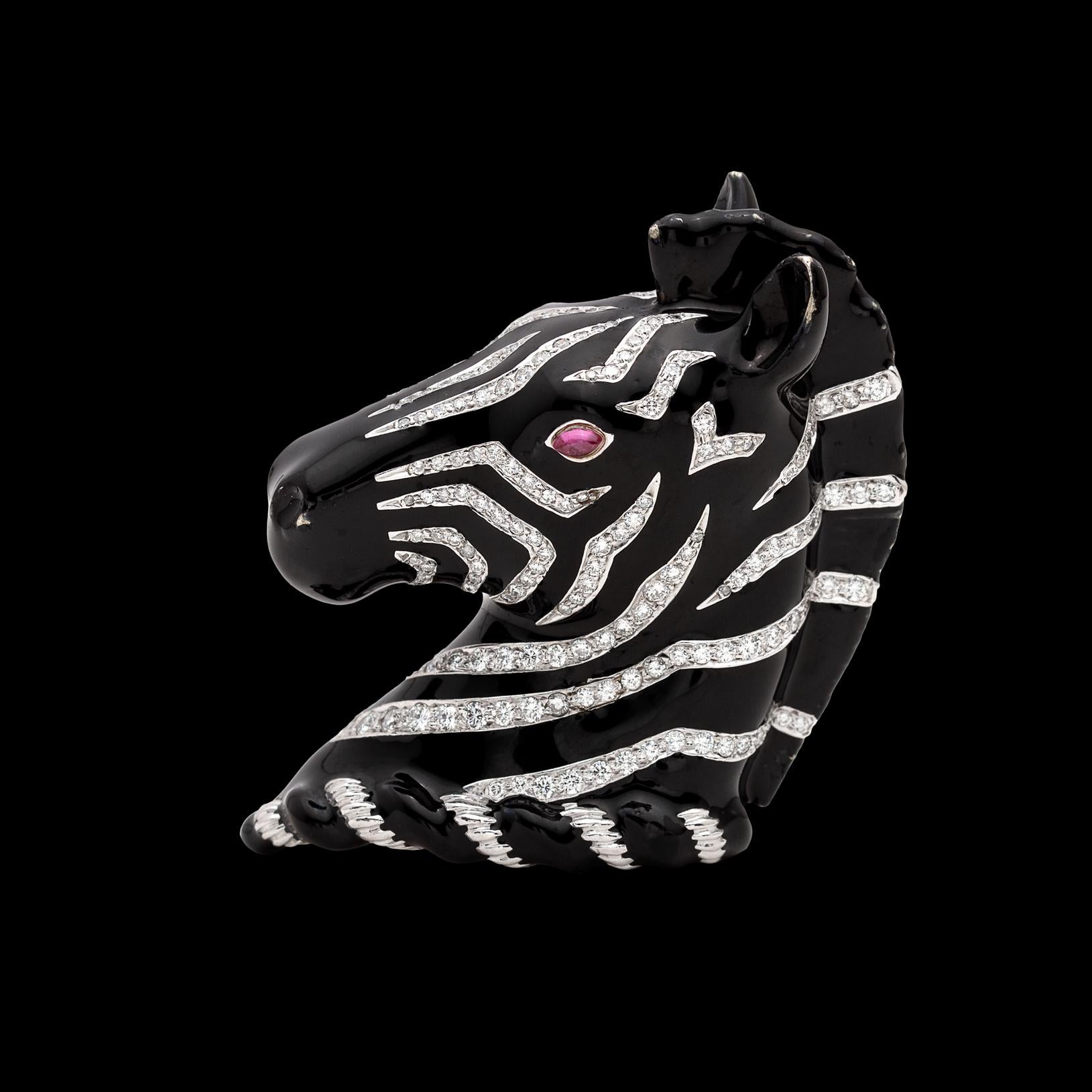 Custom and one-of-a-kind, this wonderful Verdura piece is a mini masterpiece. In 18k white gold, the black enamel zebra has diamond-set stripes, and a ruby eye. With 162 round brilliant-cut diamonds totaling an estimated 2.30 carats, it measures