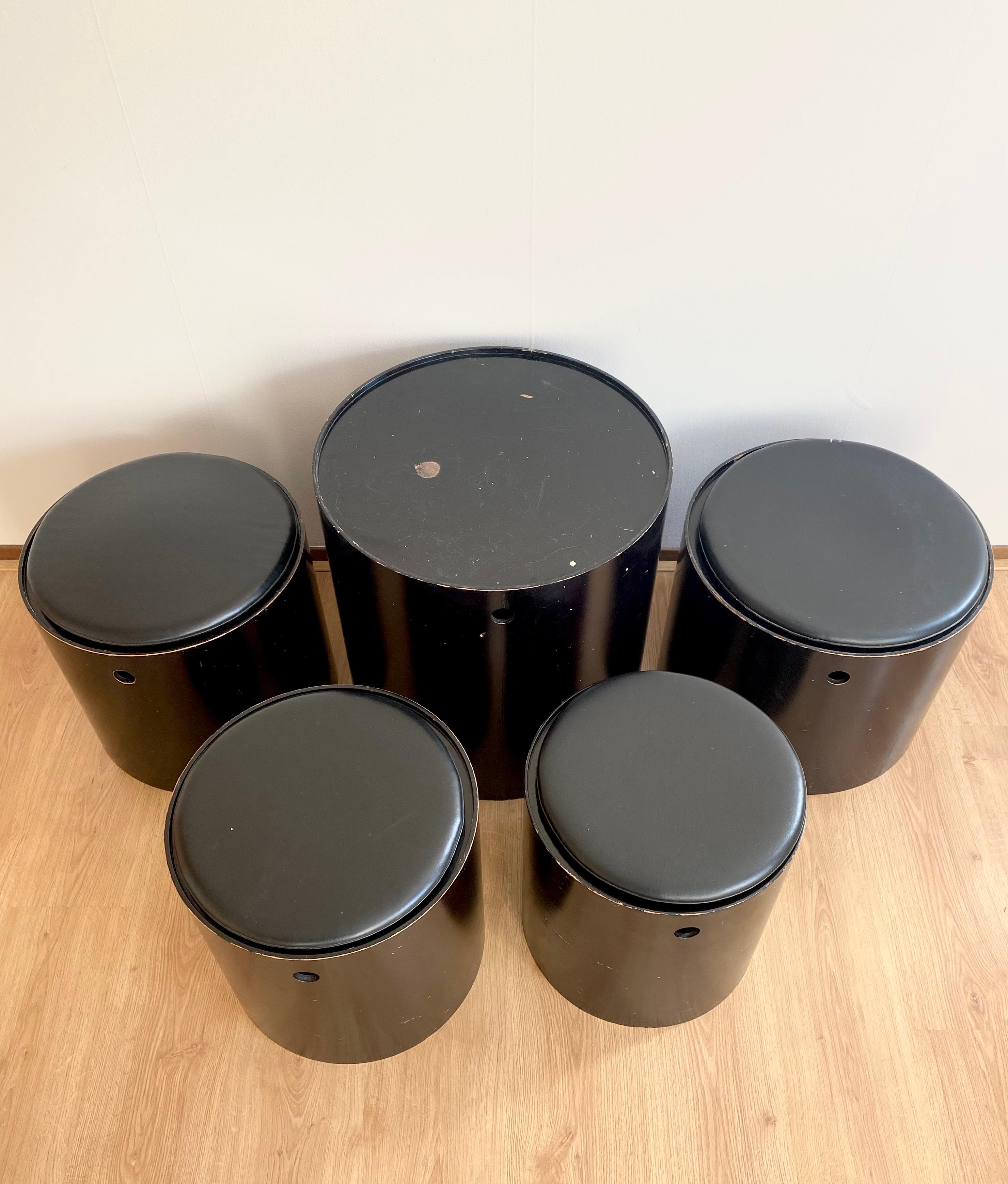 Original set consisting of four stools with Leatherette cushions and a table piece.
The seating elements were made In different sizes and were made out of bent plywood, they fit into each other. This stunning set was designed in 1965 and