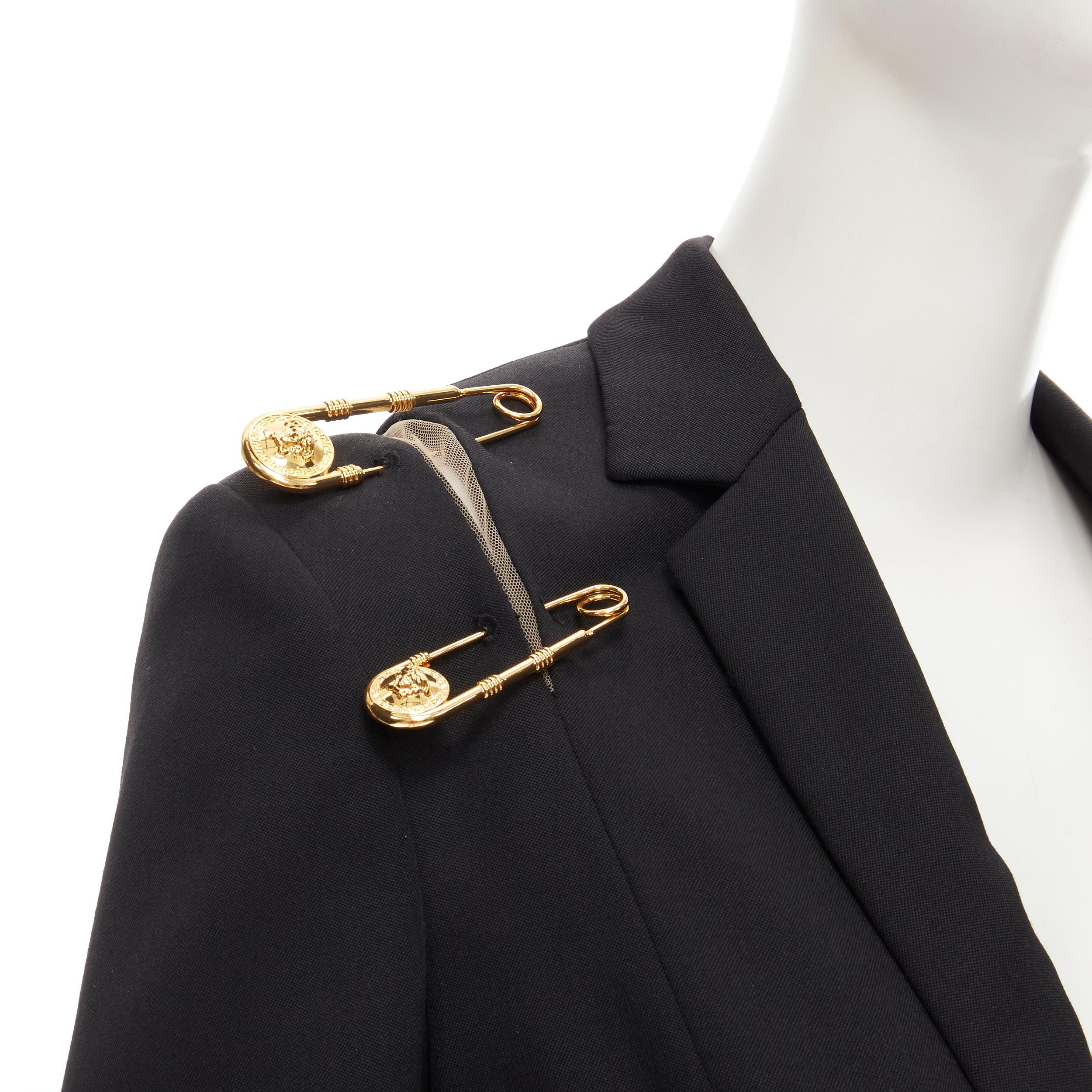 rare VERSACE black wool gold Medusa safety pin punk blazer jacket IT38 XS 
Reference: TGAS/C00370 
Brand: Versace 
Designer: Donatella Versace 
Material: Wool 
Color: Black 
Pattern: Solid 
Closure: Button 
Extra Detail: Black virgin wool upper.