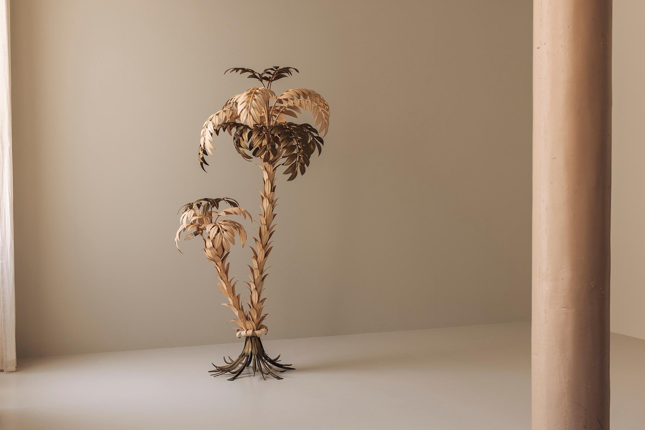 We are pleased to present a less common variation of the iconic Hans Kögl palm tree floor lamp, distinguished by its golden and cream painted leaves. Dating from the 1970s, this German-made sculptural lamp showcases Kögl’s signature craftsmanship in