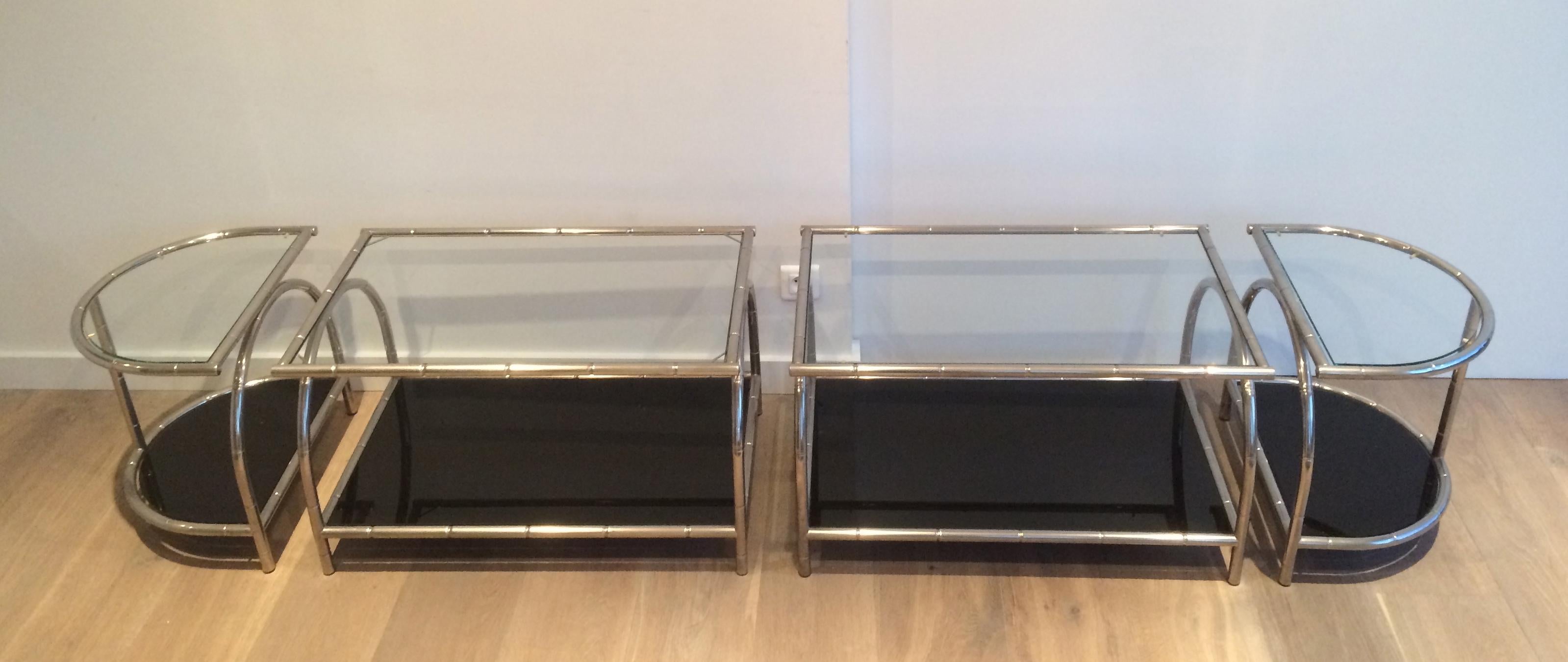 This rare very wide coffee table is made of chrome with 4 clear glass shelves on top and 4 black lacquered glass shelves on the bottom. This cocktail table is made of 4 elements: 2 rectangular coffee tables and 2 rounded tables on each side. These