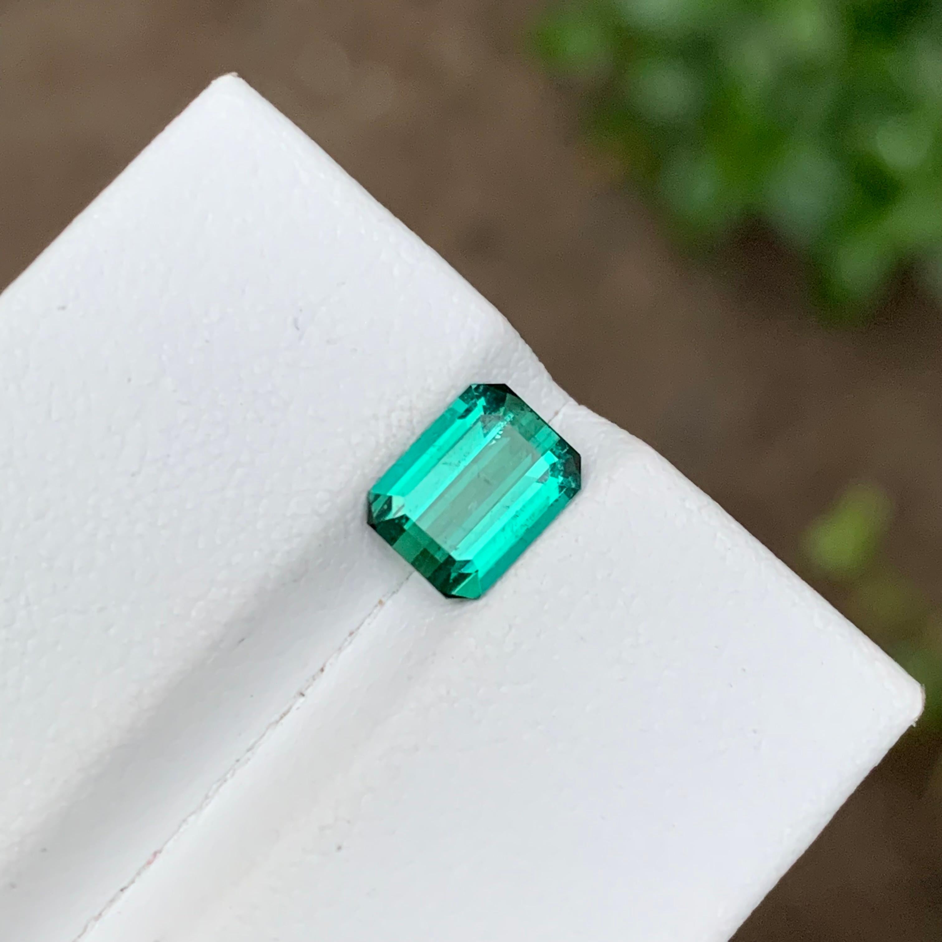 GEMSTONE TYPE: Tourmaline
PIECE(S): 1
WEIGHT: 1.35 Carats
SHAPE: Emerald
SIZE (MM): 7.49 x 5.79 x 3.38
COLOR: Vibrant Bluish Neon Green
CLARITY: Slightly Included 
TREATMENT: None
ORIGIN: Afghanistan
CERTIFICATE: On demand

Introducing our exquisite