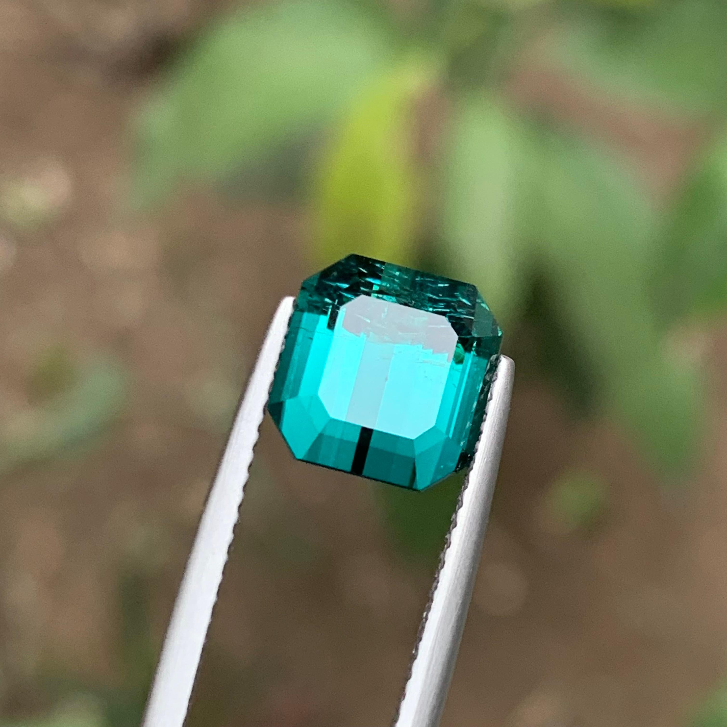 GEMSTONE TYPE: Tourmaline
PIECE(S): 1
WEIGHT: 4.20 Carat
SHAPE: Emerald
SIZE (MM): 9.08 x 8.85 x 6.04
COLOR: Vibrant Lagoon Blue
CLARITY: Slightly Included 
TREATMENT: None
ORIGIN: Afghanistan
CERTIFICATE: On demand

This captivating emerald-cut